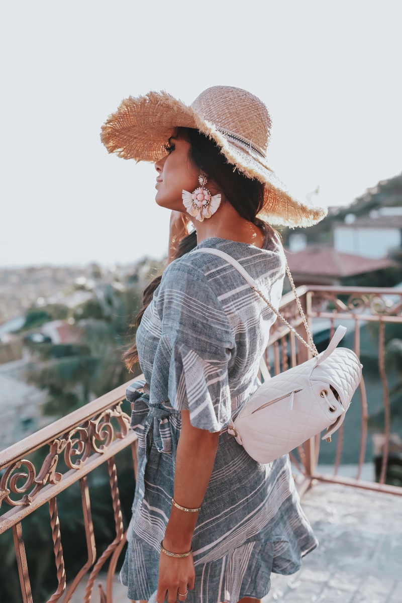 Emily Ann Gemma, The Sweetest Thing Blog, VACATION LOOK, THE CUTEST STATEMENT EARRINGS, Vacation 2018 Pinterest, Vacation outfit 2018 Pinterest, Straw hat, Chanel backpack, Chanel backpack 2018 Pinterest, White Chanel backpack, statement earrings, Express statement earrings, Express striped dress, Chanel flats, Express linen dress