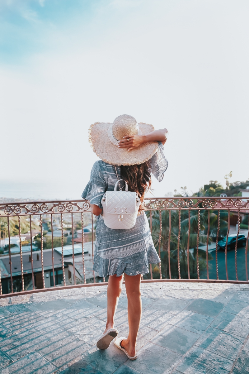 Emily Ann Gemma, The Sweetest Thing Blog, VACATION LOOK, THE CUTEST STATEMENT EARRINGS, Vacation 2018 Pinterest, Vacation outfit 2018 Pinterest, Straw hat, Chanel backpack, Chanel backpack 2018 Pinterest, White Chanel backpack, statement earrings, Express statement earrings, Express striped dress, Chanel flats, Express linen dress