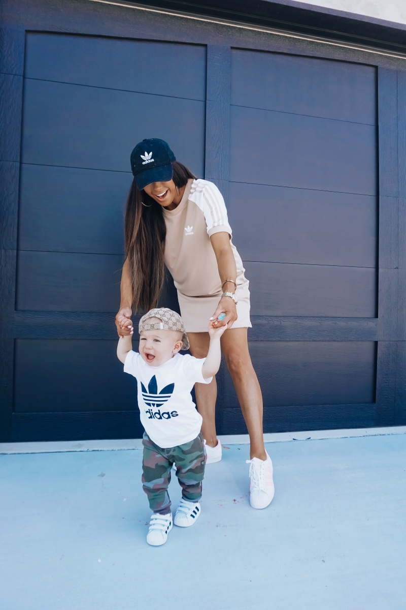 best #nsale kids outfits, cute baby boy fashion adidas, emily ann gemma, baby boy fashion fall pinterest 2018 | Cute Baby Boy Outfit by popular US fashion blog, The Sweetest Thing: image of a mom and her baby wearing Nordstrom adidas Trefoil Baseball Cap ADIDAS ORIGINALS, Nordstrom Caber Diamond Bracelet Watch, 35mm MICHELE, Nordstrom Trefoil Logo Tee ADIDAS ORIGINALS, Nordstrom Camo Knit Pants TUCKER + TATE, and Nordstrom baby Adidas shoes. 