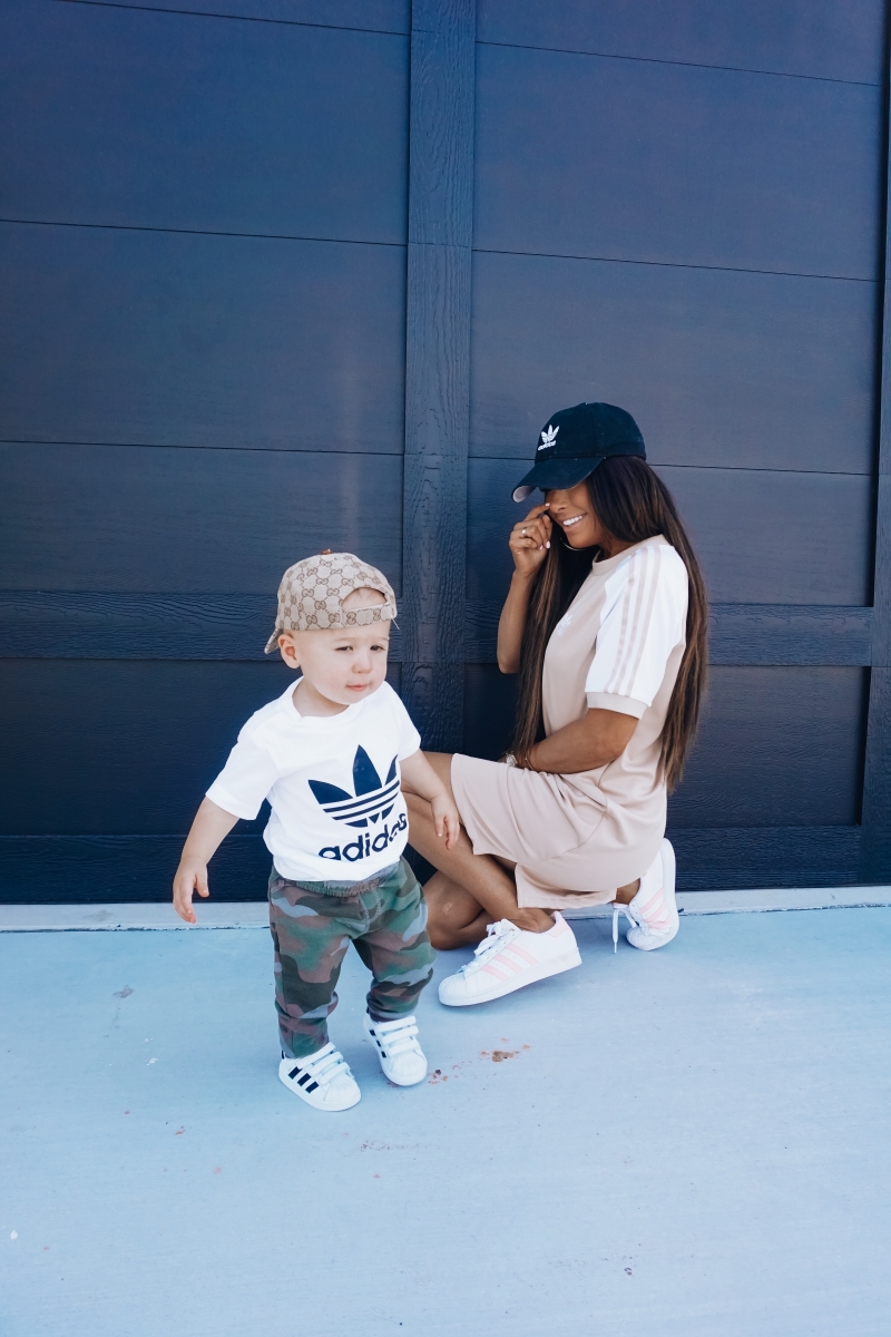 best #nsale kids outfits, cute baby boy fashion adidas, emily ann gemma, baby boy fashion fall pinterest 2018 | Cute Baby Boy Outfit by popular US fashion blog, The Sweetest Thing: image of a mom and her baby wearing Nordstrom adidas Trefoil Baseball Cap ADIDAS ORIGINALS, Nordstrom Caber Diamond Bracelet Watch, 35mm MICHELE, Nordstrom Trefoil Logo Tee ADIDAS ORIGINALS, Nordstrom Camo Knit Pants TUCKER + TATE, and Nordstrom baby Adidas shoes. 