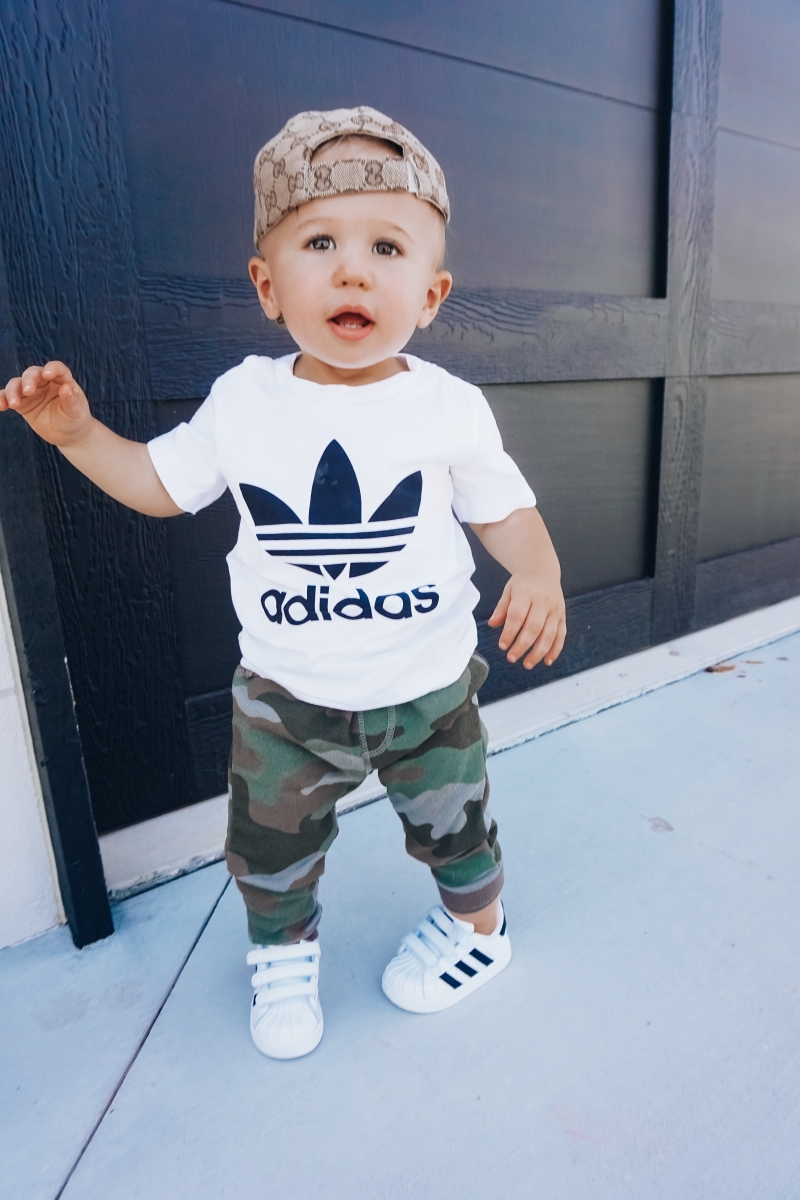 best #nsale kids outfits, cute baby boy fashion adidas, emily ann gemma, baby boy fashion fall pinterest 2018 | Cute Baby Boy Outfit by popular US fashion blog, The Sweetest Thing: image of a baby wearing a Nordstrom Trefoil Logo Tee ADIDAS ORIGINALS, Nordstrom Camo Knit Pants TUCKER + TATE, and Nordstrom baby Adidas shoes. 