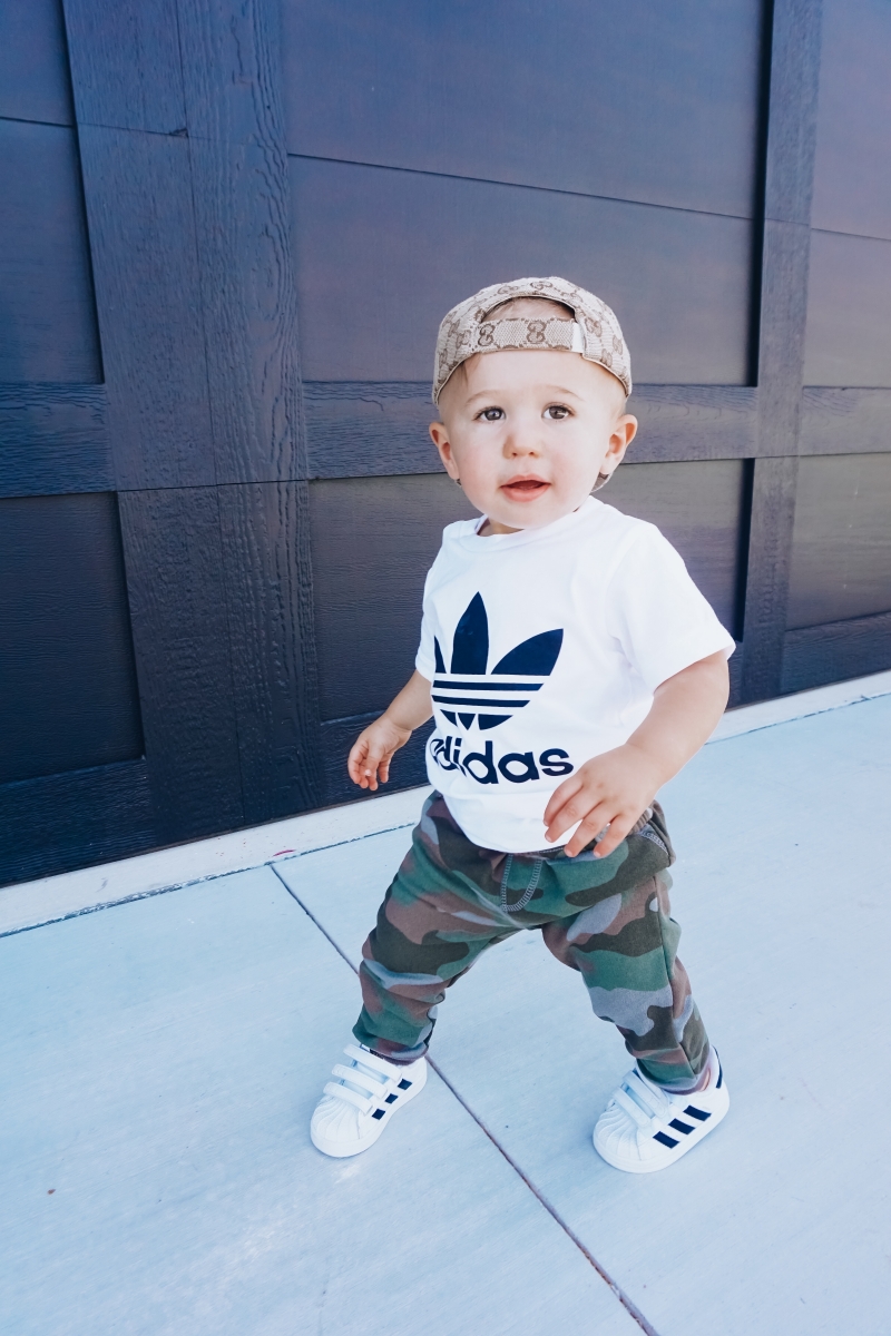 best #nsale kids outfits, cute baby boy fashion adidas, emily ann gemma, baby boy fashion fall pinterest 2018 | Cute Baby Boy Outfit by popular US fashion blog, The Sweetest Thing: image of a baby wearing a Nordstrom Trefoil Logo Tee ADIDAS ORIGINALS, Nordstrom Camo Knit Pants TUCKER + TATE, and Nordstrom baby Adidas shoes. 