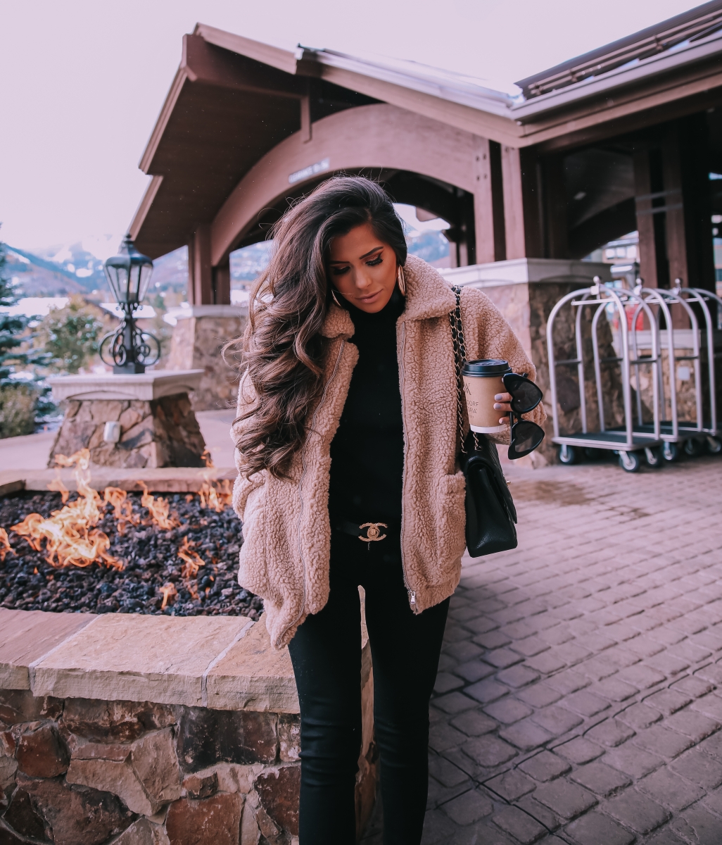 Fall fashion pinterest 2018, teddy bear coat outfit pinterest 2018, IAMGIA teddy coat, chanel belt outfit, park city travel fashion blogger, emily gemma blog, chanel classic black maxi-3 | I Am Gia Teddy Bear Jacket by popular US fashion blog, The Sweetest Thing: image of a woman standing outside next to a gas fire pit and wearing a Pixie Coat  I.AM.GIA brand: I.AM.GIA, H&M Ribbed Turtleneck Top, Nordstrom Florence Instasculpt Ankle Skinny Jeans DL1961, ShopBop Ash boots, H&M Large Earrings, Nordstrom Lip Cheat Lip Liner CHARLOTTE TILBURY, Chanel belt, Chanel purse, and Nordstrom MAC Matte Lipstick MAC COSMETICS.