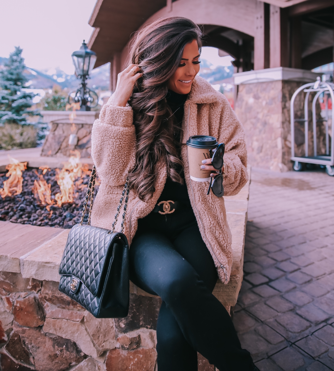 Fall fashion pinterest 2018, teddy bear coat outfit pinterest 2018, IAMGIA teddy coat, chanel belt outfit, park city travel fashion blogger, emily gemma blog, chanel classic black maxi-3 | I Am Gia Teddy Bear Jacket by popular US fashion blog, The Sweetest Thing: image of a woman standing outside next to a gas fire pit and wearing a Pixie Coat  I.AM.GIA brand: I.AM.GIA, H&M Ribbed Turtleneck Top, Nordstrom Florence Instasculpt Ankle Skinny Jeans DL1961, ShopBop Ash boots, H&M Large Earrings, Nordstrom Lip Cheat Lip Liner CHARLOTTE TILBURY, Chanel belt, Chanel purse, and Nordstrom MAC Matte Lipstick MAC COSMETICS.