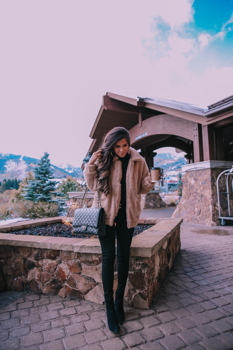 Fall fashion pinterest 2018, teddy bear coat outfit pinterest 2018, IAMGIA teddy coat, chanel belt outfit, park city travel fashion blogger, emily gemma blog, chanel classic black maxi-3 | I Am Gia Teddy Bear Jacket by popular US fashion blog, The Sweetest Thing: image of a woman standing outside next to a gas fire pit and wearing a Pixie Coat  I.AM.GIA brand: I.AM.GIA, H&M Ribbed Turtleneck Top, Nordstrom Florence Instasculpt Ankle Skinny Jeans DL1961, ShopBop Ash boots, H&M Large Earrings, Nordstrom Lip Cheat Lip Liner CHARLOTTE TILBURY, Chanel belt, Chanel purse, and Nordstrom MAC Matte Lipstick MAC COSMETICS.