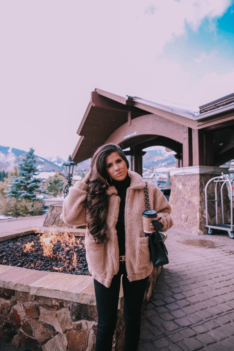 Fall fashion pinterest 2018, teddy bear coat outfit pinterest 2018, IAMGIA teddy coat, chanel belt outfit, park city travel fashion blogger, emily gemma blog, chanel classic black maxi-3 | I Am Gia Teddy Bear Jacket by popular US fashion blog, The Sweetest Thing: image of a woman standing outside next to a gas fire pit and wearing a Pixie Coat  I.AM.GIA brand: I.AM.GIA, H&M Ribbed Turtleneck Top, Nordstrom Florence Instasculpt Ankle Skinny Jeans DL1961, ShopBop Ash boots, H&M Large Earrings, Nordstrom Lip Cheat Lip Liner CHARLOTTE TILBURY, Chanel belt, Chanel purse, and Nordstrom MAC Matte Lipstick MAC COSMETICS.