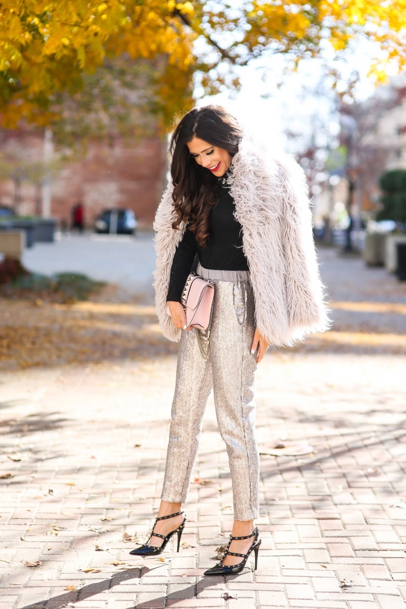 styling sequins holidays 2018, emily ann gemma, sequin pant outfit idea 2018 pinterest | Sequin Leggings Outfit by popular US fashion blog, The Sweetest Thing: image of a woman wearing gold sequin pants, a cream faux shag fur jacket, black shirt and black stud heels. 