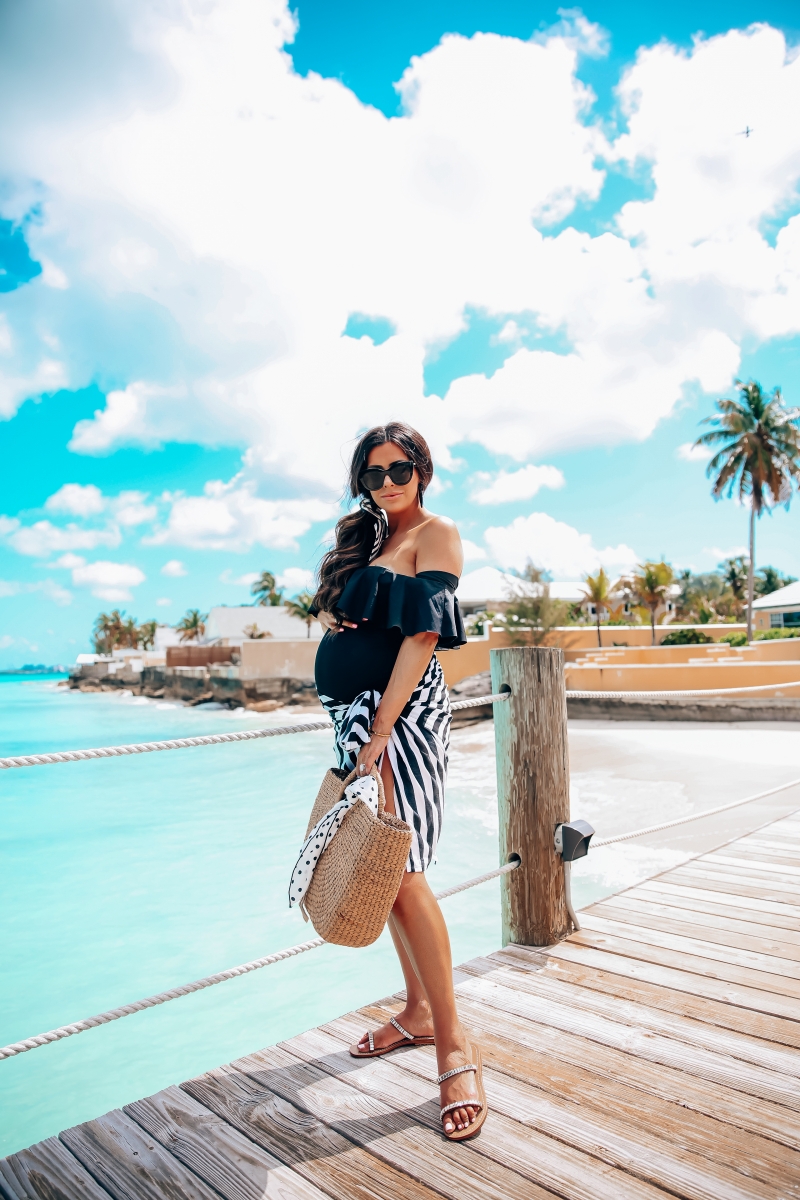 one piece black swimsuit off the shoulder with ruffle, sandals bahamas, meghan markle black sunglasses, emily gemma, one piece maternity swimsuit, pregnancy fashion spring and summer, the sweetest thing blog, meghan marble black le spec sunglasses,