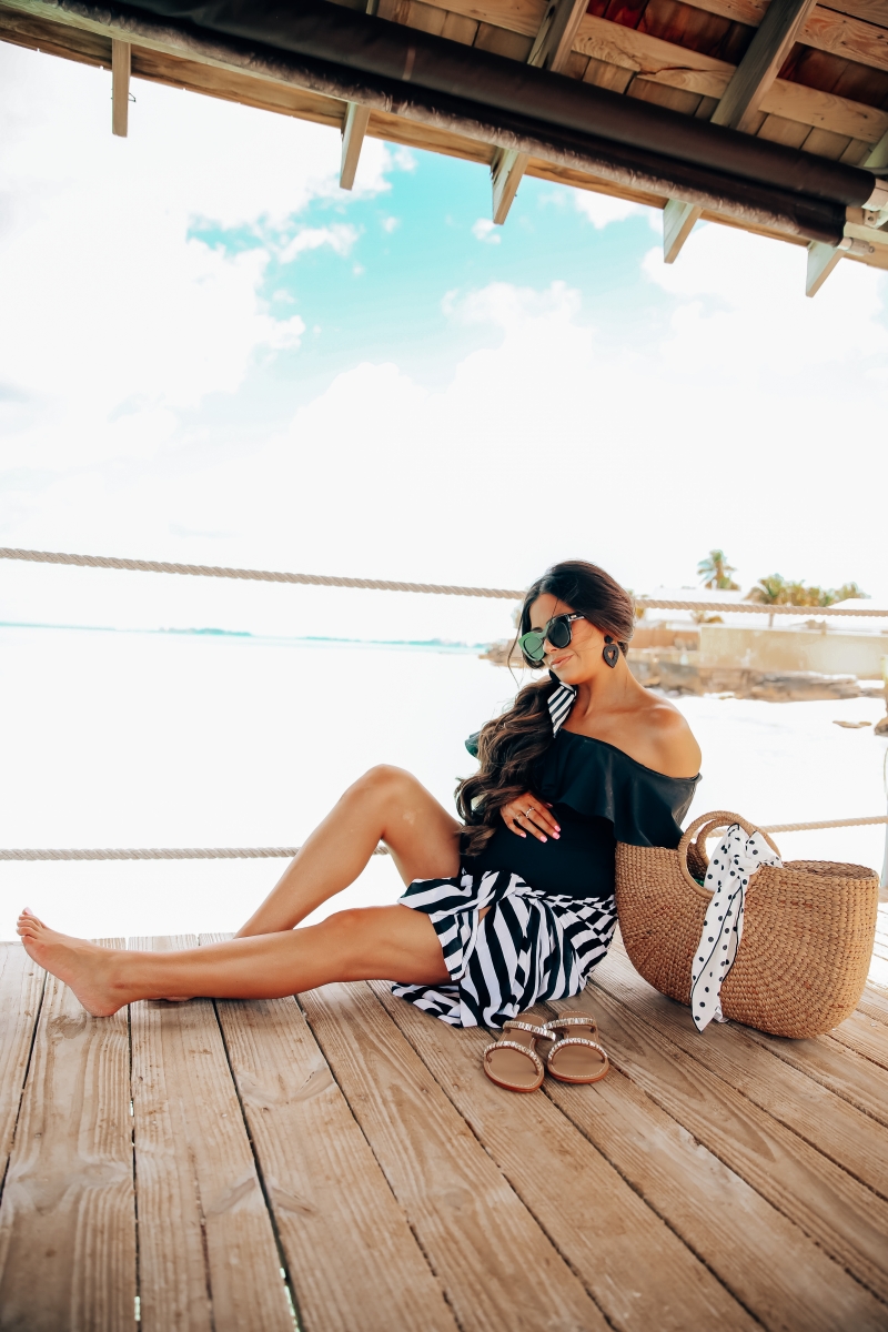 one piece black swimsuit off the shoulder with ruffle, sandals bahamas, meghan markle black sunglasses, emily gemma, one piece maternity swimsuit, pregnancy fashion spring and summer, the sweetest thing blog, meghan marble black le spec sunglasses,