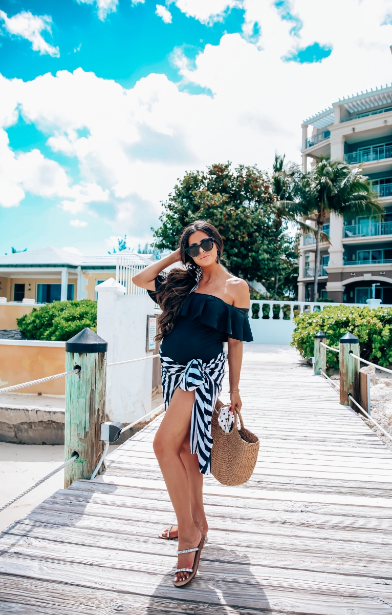 one piece black swimsuit off the shoulder with ruffle, sandals bahamas, meghan markle black sunglasses, emily gemma, one piece maternity swimsuit, pregnancy fashion spring and summer, the sweetest thing blog, meghan marble black le spec sunglasses,