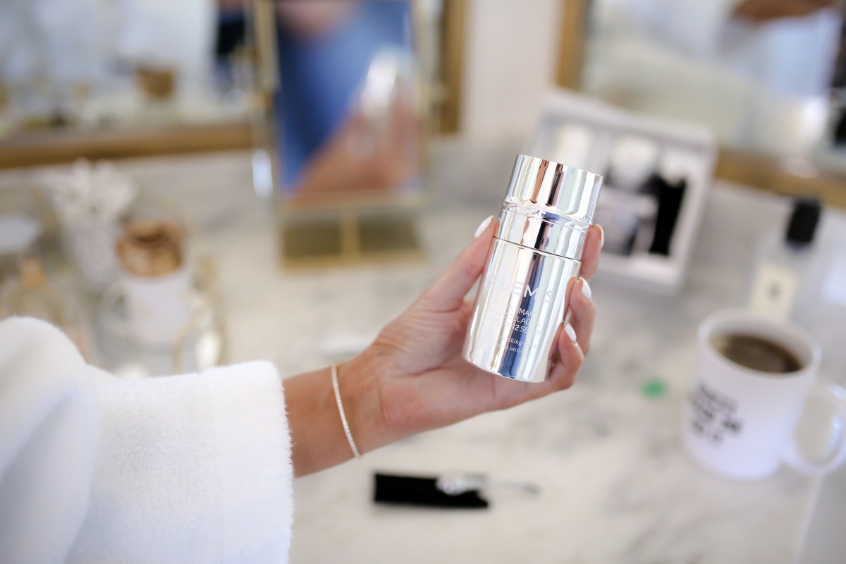 Elemis Pro Collagen Skin Care Line by Popular US beauty blog, The Sweetest Thing: image of a woman holding an Elemis Pro Collagen skin care product. 
