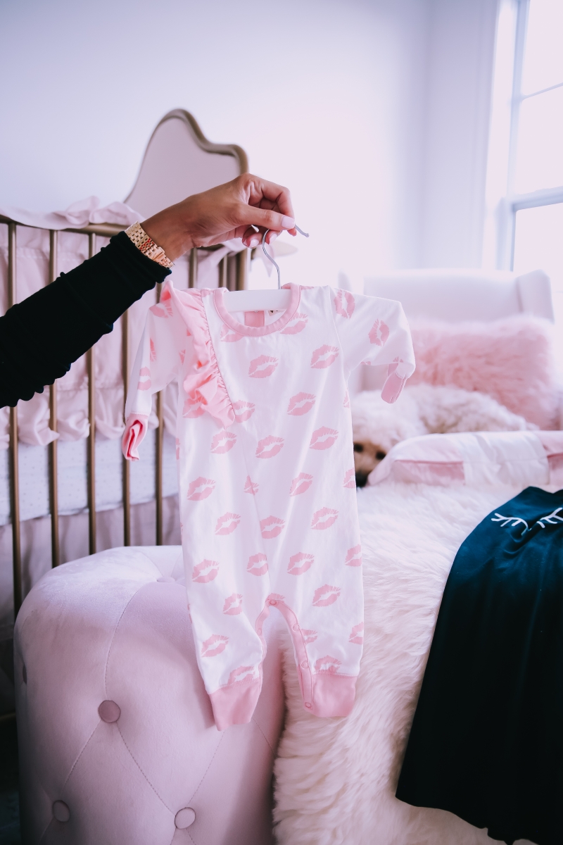 Emily Ann Gemma of The Sweetest Thing Blog in baby girl nursery. Favorite baby onesie.