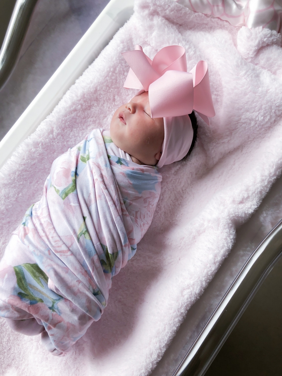 Emily Ann Gemma of The Sweetest Thing Blog with new baby. Cute baby bow and swaddling blanket.