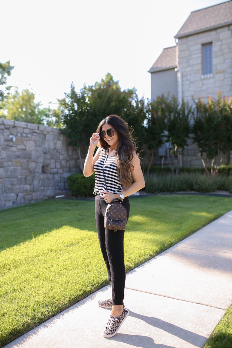 Emily Ann Gemma of The Sweetest Thing blog shares an affordable, Everyday Outfit Under $100 from Walmart. Louis Vuitton backpack, leopard shoes, striped tank, and black pants.