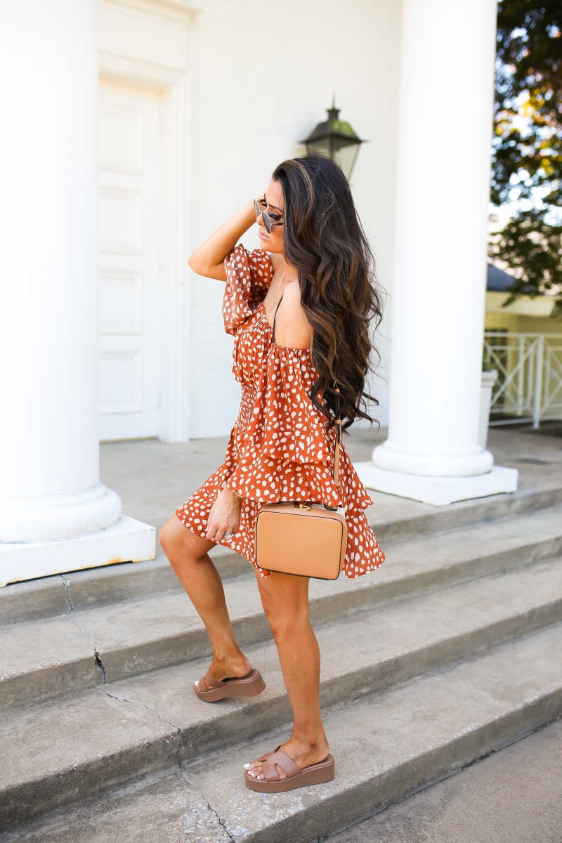 Emily Ann Gemma of The Sweetest Thing Blog's favorite summer dress for under $30. Orange and white polka dot dress, brown wedge heels, deisgner purse.