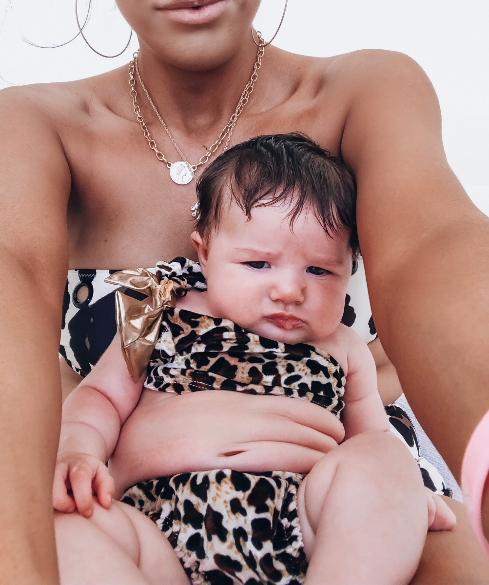 baby girl fashion, leopard baby swimsuit, mom and baby fashion pinterest, emily ann gemma | Instagram Recap by popular US life an style blog, The Sweetest Thing: image of Emily Gemma holding a baby girl in her lap and wearing a Solid & Striped The Annabelle Bikini Top, Solid & Striped The Bridgette Bikini Bottoms, Nordstrom Extra Large Icon Hoop Earrings JENNY BIRD, The Styled Collection MADEMOISELLE NECKLACE, and Amazon Turuste Newborn Toddler Girls Bikini Swimsuit. 