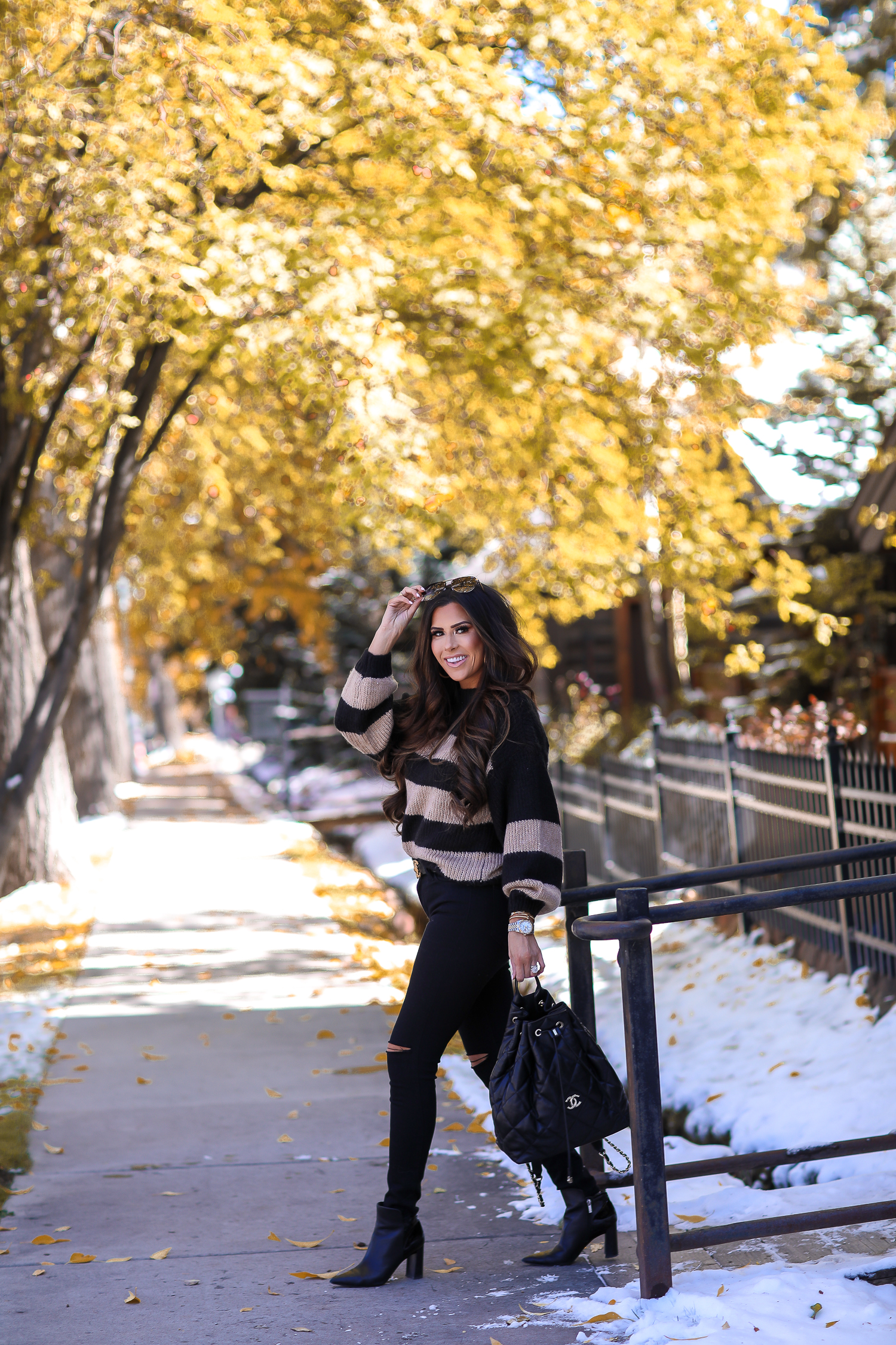 Easy Fall Look styled by top US fashion blog, The Sweetest Thing: image of a woman wearing a Nordstrom striped sweater, Madewell jeans, Marc Fisher booties, Chanel belt, and a Rolex watch | Fall outift ideas 2019 pinterest, Aspen what to wear fall, black chanel backpack quilted 2019, quay rimless aviator black, emily gemma, top popular fall fashion bloggers-2