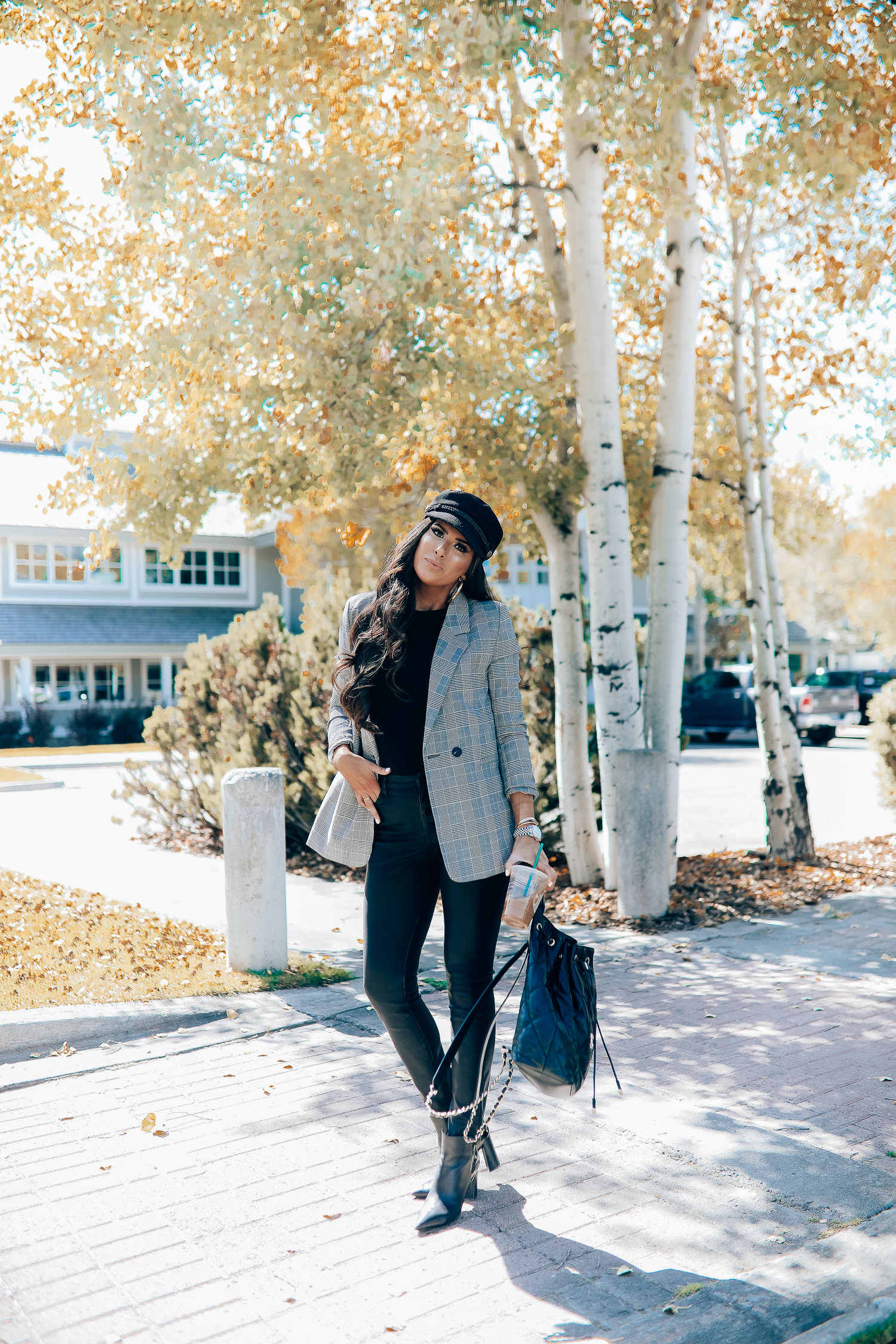 Oversized plaid blazer styled for Fall by top US fashion blog, The Sweetest Thing: image of a woman wearing an Aqua oversized plaid blazer, Splendid long sleeve top, BlankNYC vegan leggings, Marc Fisher booties, Chanel backpack, Baker boy cap, a Rolex watch, Argento Vivo earrings, and Cartier bracelets