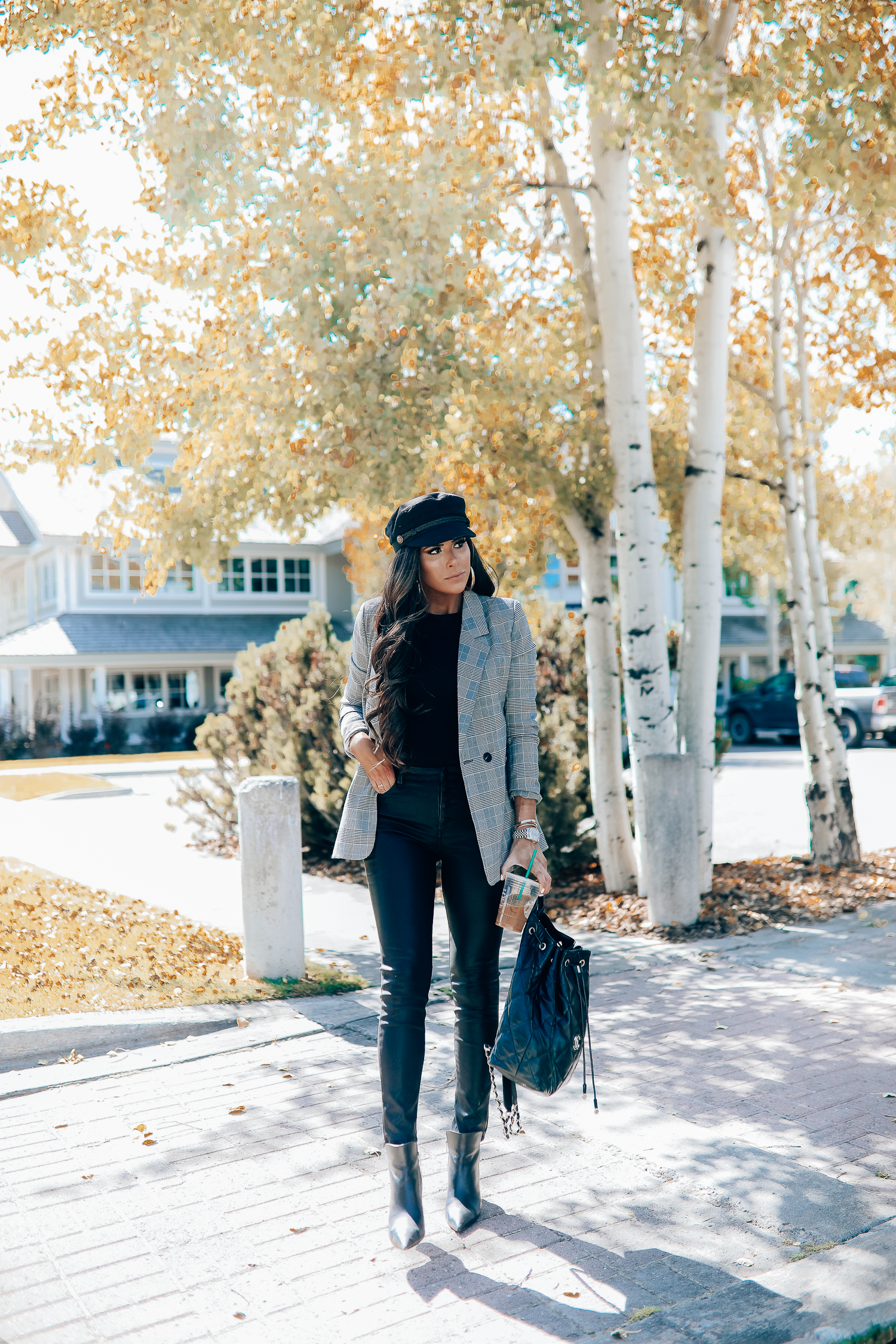 Oversized plaid blazer styled for Fall by top US fashion blog, The Sweetest Thing: image of a woman wearing an Aqua oversized plaid blazer, Splendid long sleeve top, BlankNYC vegan leggings, Marc Fisher booties, Chanel backpack, Baker boy cap, a Rolex watch, Argento Vivo earrings, and Cartier bracelets