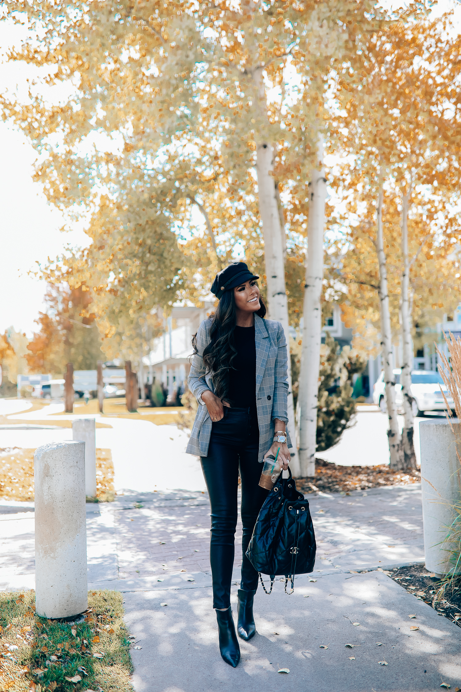 Oversized plaid blazer styled for Fall by top US fashion blog, The Sweetest Thing: image of a woman wearing an Aqua oversized plaid blazer, Splendid long sleeve top, BlankNYC vegan leggings, Marc Fisher booties, Chanel backpack, Baker boy cap, a Rolex watch, Argento Vivo earrings, and Cartier bracelets | fall fashion outfits pinterest 2019, plaid blazer outfit fall, leather pants outfit fall, how to style a plaid blazer fall trends 2019, emily ann gemma-19