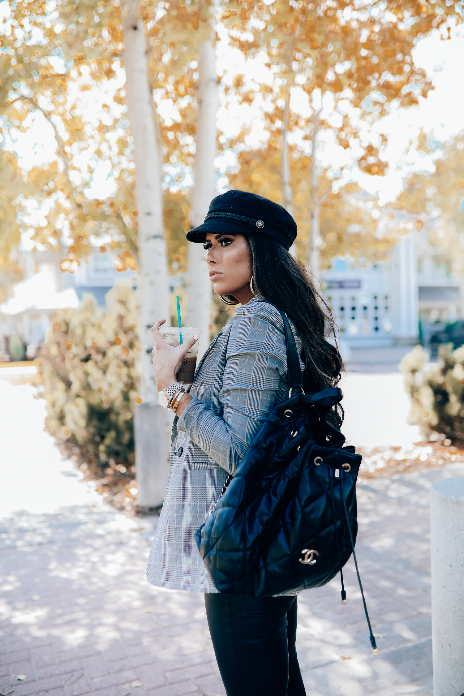 Oversized plaid blazer styled for Fall by top US fashion blog, The Sweetest Thing: image of a woman wearing an Aqua oversized plaid blazer, Splendid long sleeve top, BlankNYC vegan leggings, Marc Fisher booties, Chanel backpack, Baker boy cap, a Rolex watch, Argento Vivo earrings, and Cartier bracelets | fall fashion outfits pinterest 2019, plaid blazer outfit fall, leather pants outfit fall, how to style a plaid blazer fall trends 2019, emily ann gemma-19