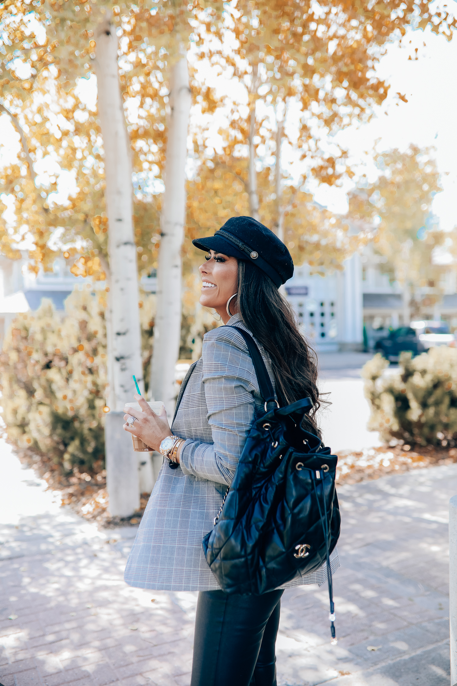 Oversized plaid blazer styled for Fall by top US fashion blog, The Sweetest Thing: image of a woman wearing an Aqua oversized plaid blazer, Splendid long sleeve top, BlankNYC vegan leggings, Marc Fisher booties, Chanel backpack, Baker boy cap, a Rolex watch, Argento Vivo earrings, and Cartier bracelets | fall fashion outfits pinterest 2019, plaid blazer outfit fall, leather pants outfit fall, how to style a plaid blazer fall trends 2019, emily ann gemma-19