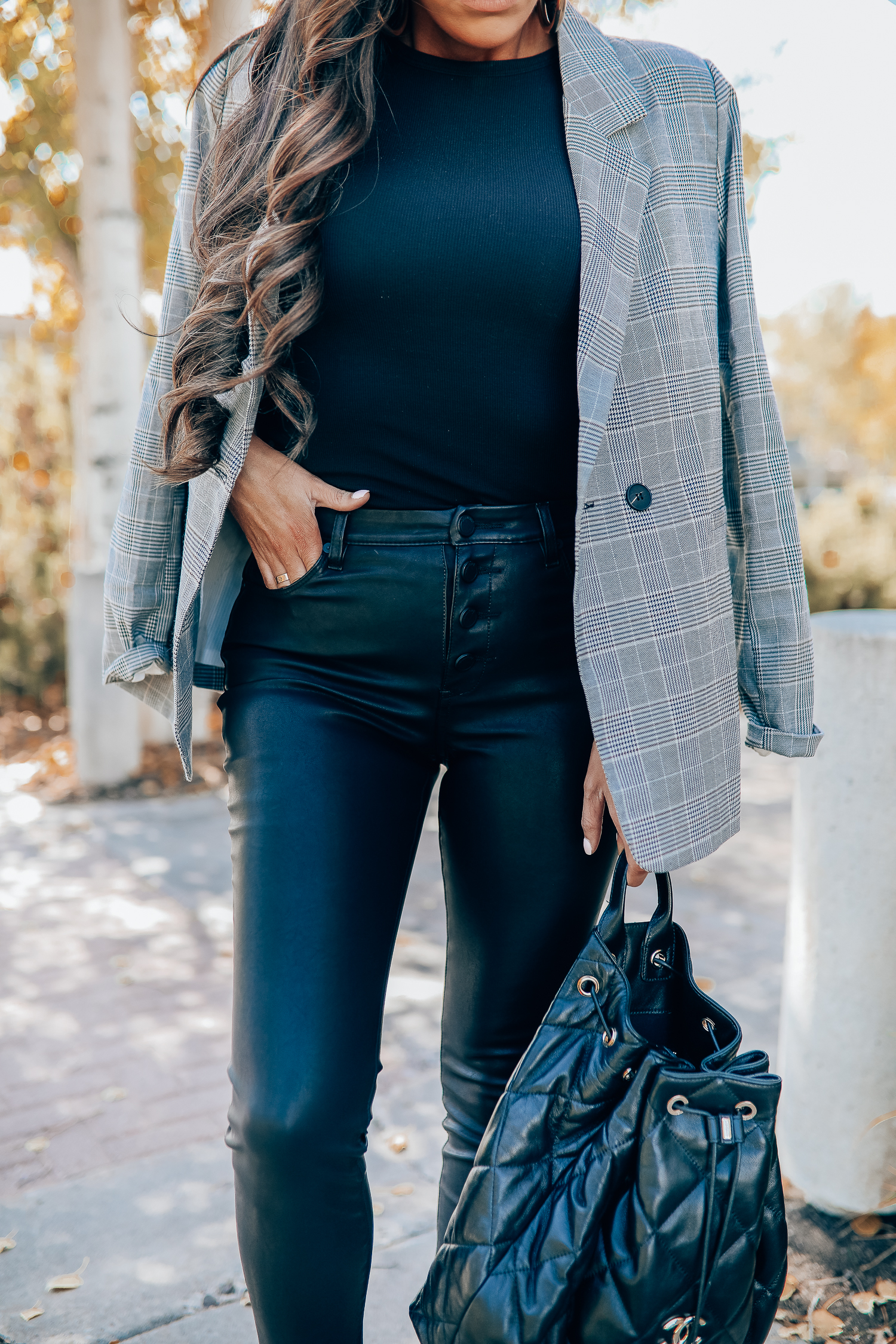 Oversized plaid blazer styled for Fall by top US fashion blog, The Sweetest Thing: image of a woman wearing an Aqua oversized plaid blazer, Splendid long sleeve top, BlankNYC vegan leggings, Marc Fisher booties, Chanel backpack, Baker boy cap, a Rolex watch, Argento Vivo earrings, and Cartier bracelets | fall fashion outfits pinterest 2019, plaid blazer outfit fall, leather pants outfit fall, how to style a plaid blazer fall trends 2019, emily ann gemma-19