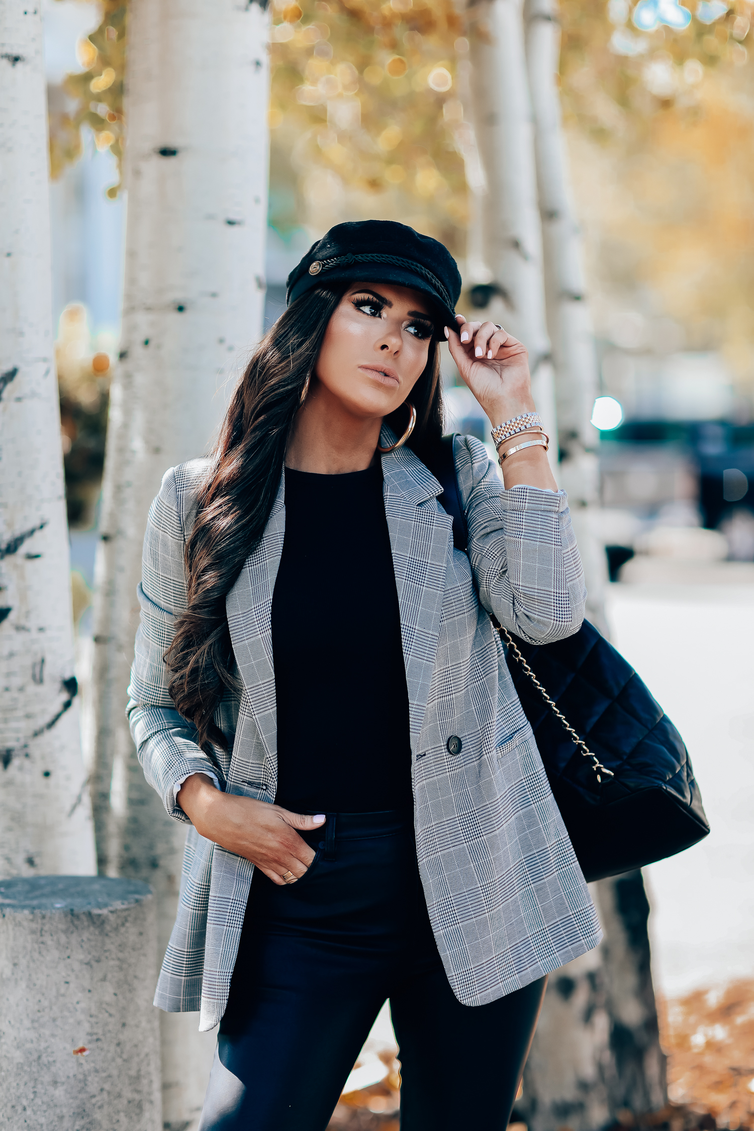 Oversized plaid blazer styled for Fall by top US fashion blog, The Sweetest Thing: image of a woman wearing an Aqua oversized plaid blazer, Splendid long sleeve top, BlankNYC vegan leggings, Marc Fisher booties, Chanel backpack, Baker boy cap, a Rolex watch, Argento Vivo earrings, and Cartier bracelets | fall fashion outfits pinterest 2019, plaid blazer outfit fall, leather pants outfit fall, how to style a plaid blazer fall trends 2019, emily ann gemma-19