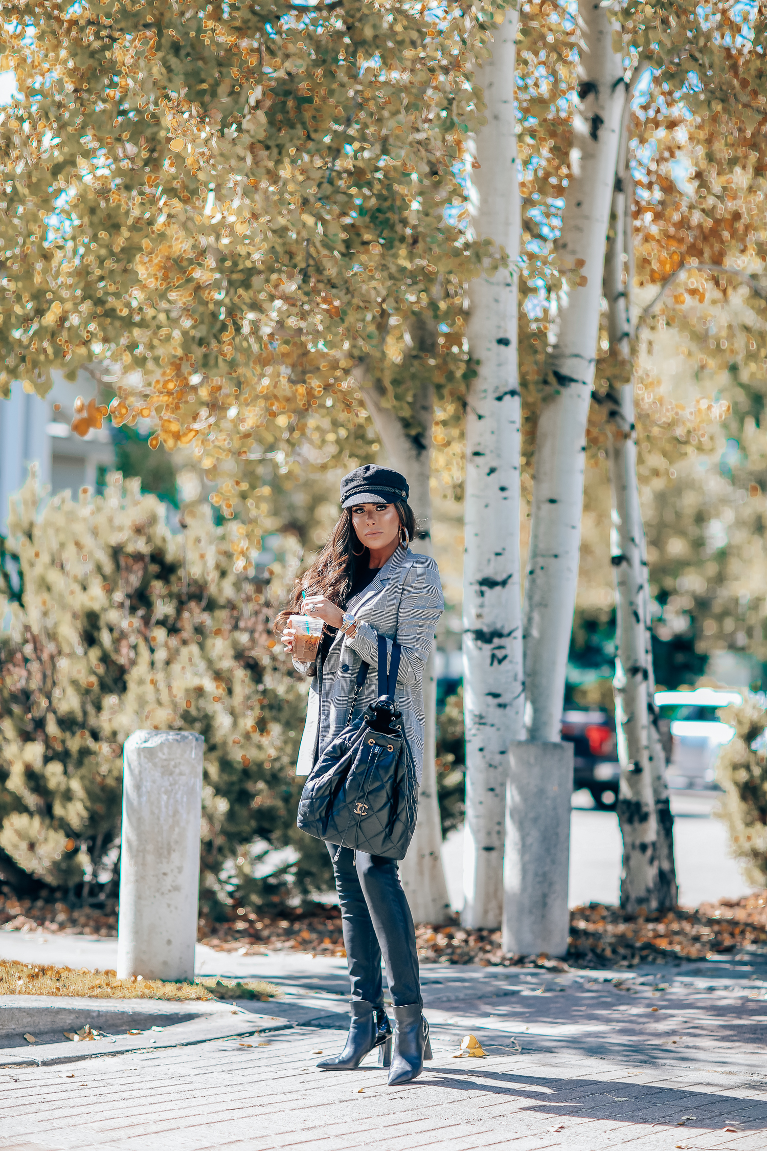 Oversized plaid blazer styled for Fall by top US fashion blog, The Sweetest Thing: image of a woman wearing an Aqua oversized plaid blazer, Splendid long sleeve top, BlankNYC vegan leggings, Marc Fisher booties, Chanel backpack, Baker boy cap, a Rolex watch, Argento Vivo earrings, and Cartier bracelets | fall fashion outfits pinterest 2019, plaid blazer outfit fall, leather pants outfit fall, how to style a plaid blazer fall trends 2019, emily ann gemma-19