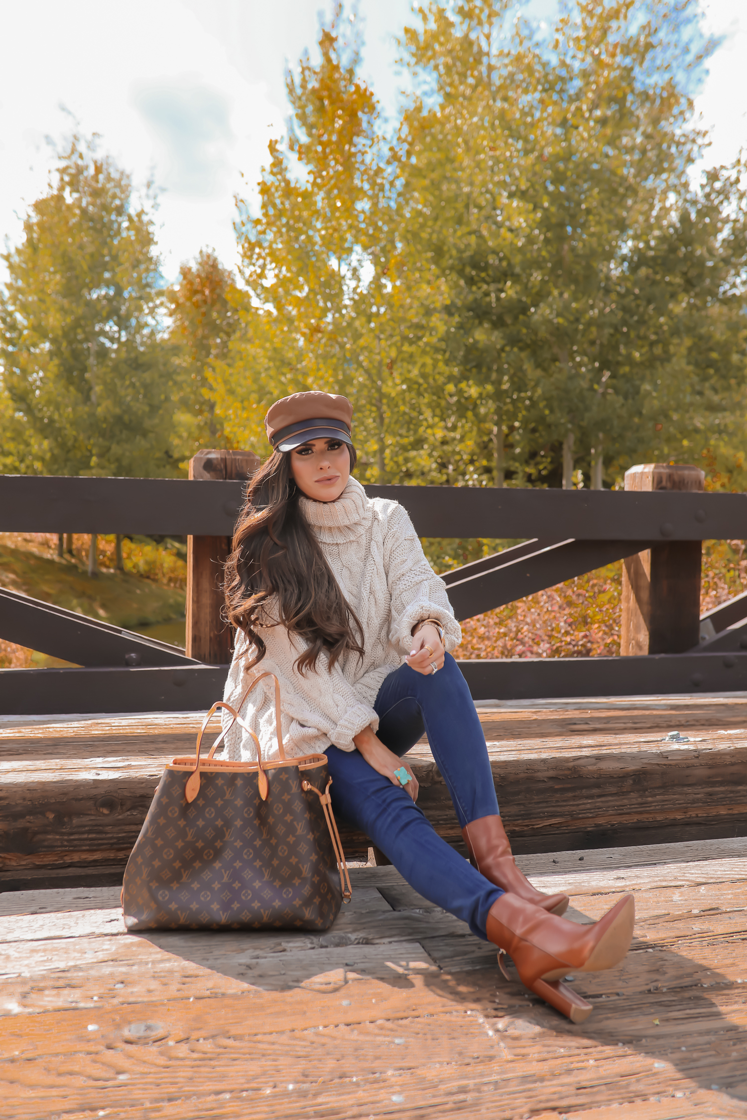 Cable knit sweater styled for Fall by top US fashion blog, The Sweetest Thing: image of a woman wearing a Topshop cable knit sweater, Express jeans, Steve Madden booties, Louis Vuitton handbag and Free People Ring.