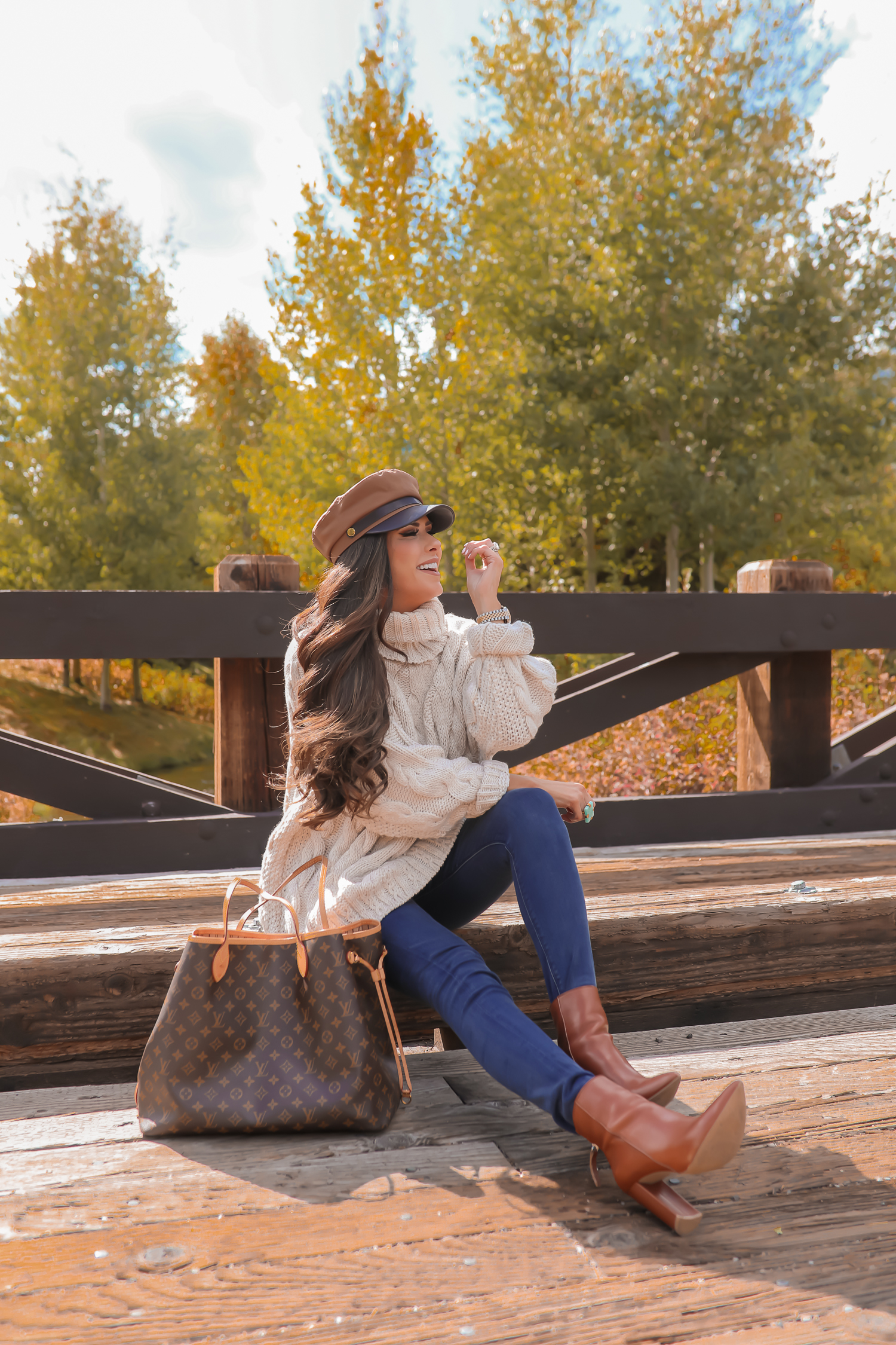 Cable knit sweater styled for Fall by top US fashion blog, The Sweetest Thing: image of a woman wearing a Topshop cable knit sweater, Express jeans, Steve Madden booties, Louis Vuitton handbag and Free People Ring | jackson hole fashion blogger, fall fashion 2019, oversized sweaters topshop nordstorm