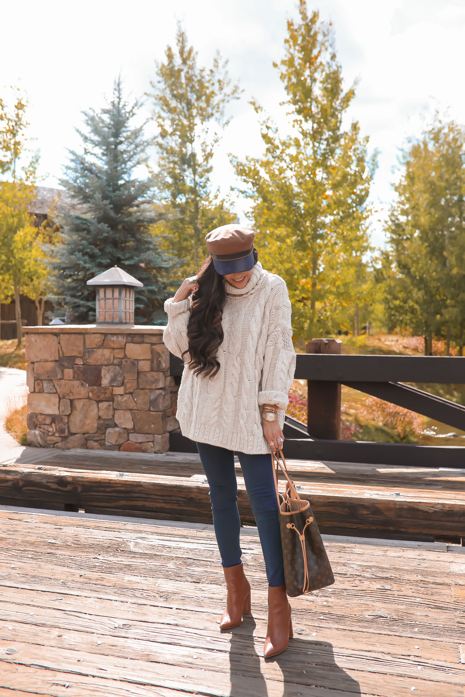 Cable knit sweater styled for Fall by top US fashion blog, The Sweetest Thing: image of a woman wearing a Topshop cable knit sweater, Express jeans, Steve Madden booties, Louis Vuitton handbag and Free People Ring.