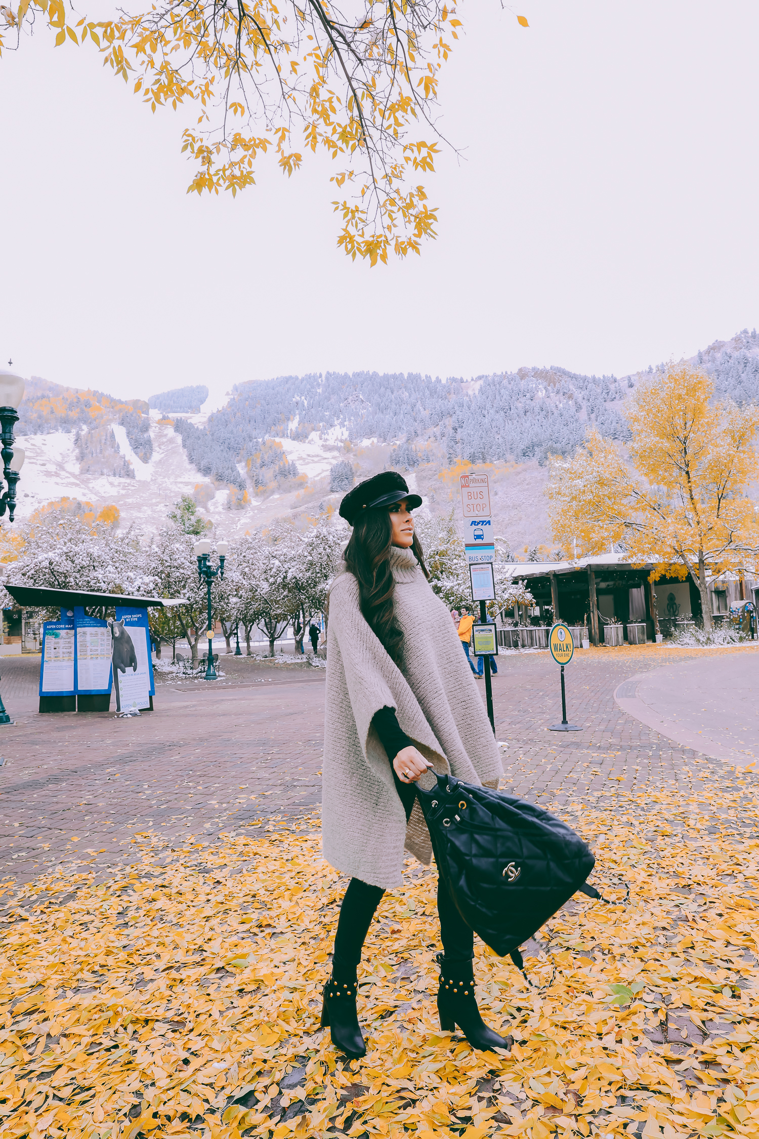 Cute snow day outfits styled by top US fashion blog, The Sweetest Thing: image of a woman wearing a Caslon black top, BlankNYC pants, See by Chloe boots, Leith baker boy cap, and a Chanel backpack | winter 2019 fashion outfits pinterest, mango cape poncho, chanel black quilted backpack, aspen fashion blogger, emily gemma, cute outfits for aspen-2