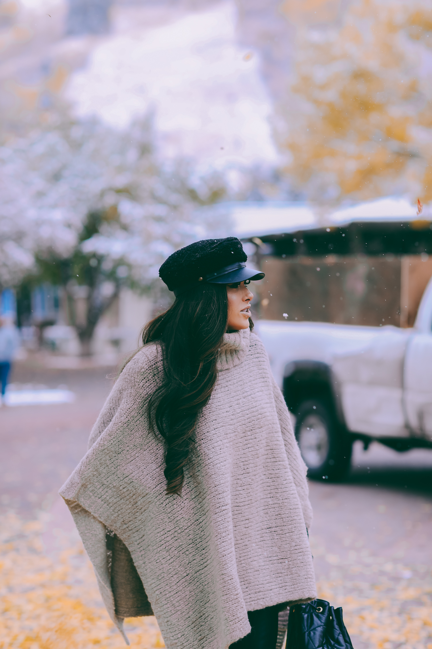 Cute snow day outfits styled by top US fashion blog, The Sweetest Thing: image of a woman wearing a Caslon black top, BlankNYC pants, See by Chloe boots, Leith baker boy cap, and a Chanel backpack | winter 2019 fashion outfits pinterest, mango cape poncho, chanel black quilted backpack, aspen fashion blogger, emily gemma, cute outfits for aspen-2