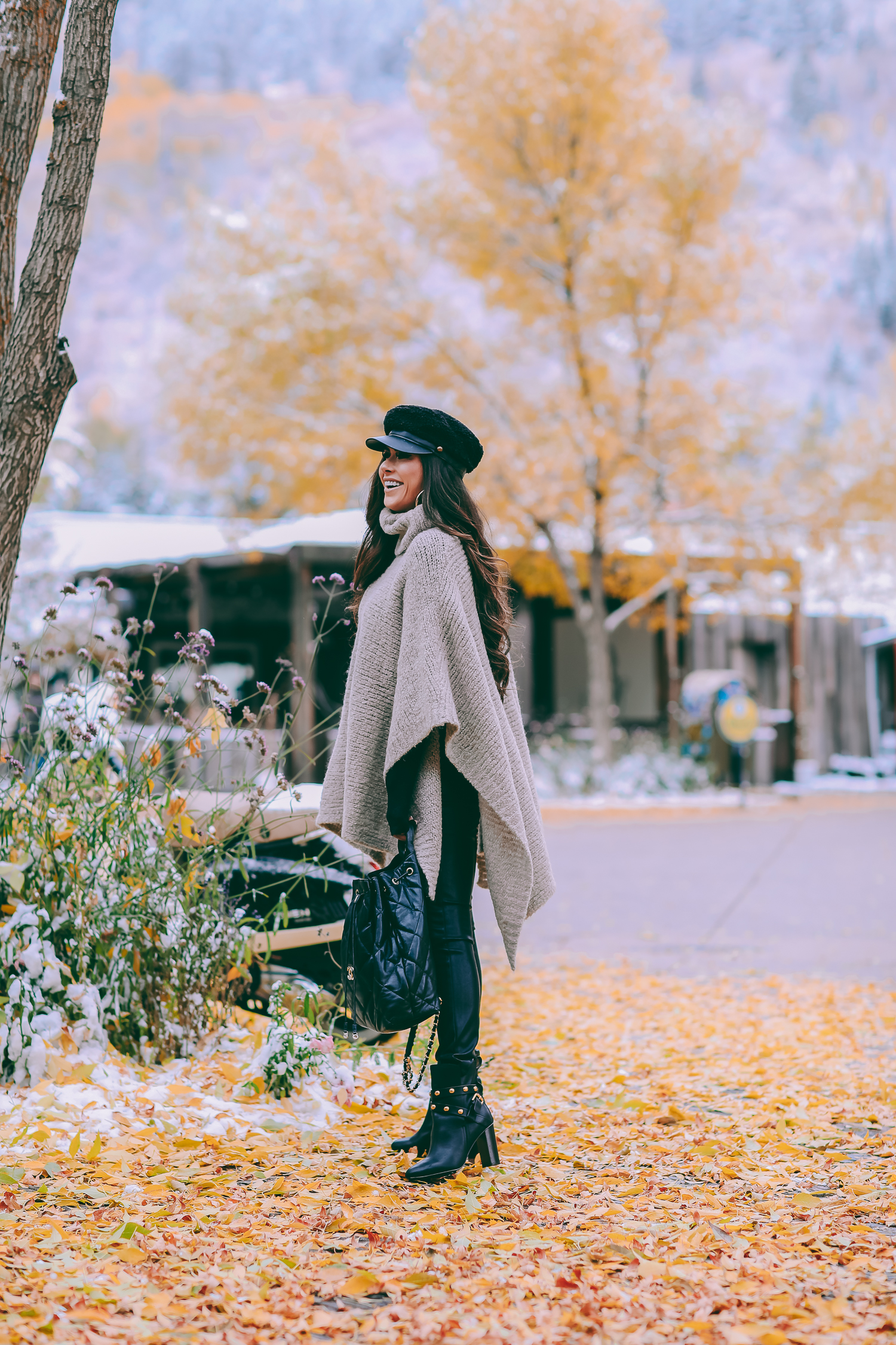 Cute snow day outfits styled by top US fashion blog, The Sweetest Thing: image of a woman wearing a Caslon black top, BlankNYC pants, See by Chloe boots, Leith baker boy cap, and a Chanel backpack | winter 2019 fashion outfits pinterest, mango cape poncho, chanel black quilted backpack, aspen fashion blogger, emily gemma, cute outfits for aspen-2