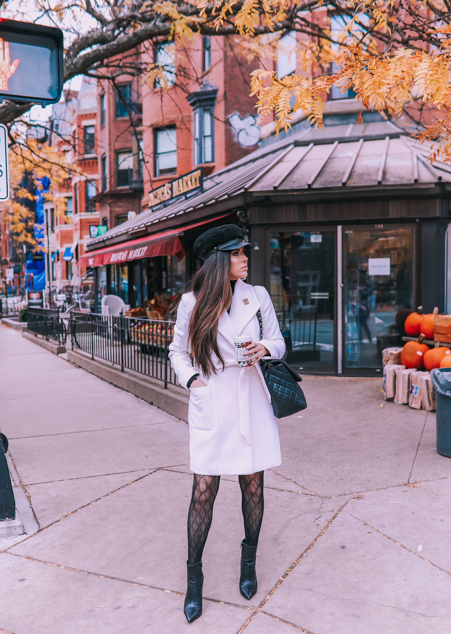 Classic Winter Outfit featured by top US fashion blog, The Sweetest Thing: image of a woman wearing an Express white coat, an Express black turtleneck, an Express tweed skirt, Gucci tights, and a Chanel bag. | fall outfit ideas pinterest 2019, black gucci tights outfit idea, pinterest gucci tight outfit idea, emily ann gemma, express fall fashion 2019, emily ann gemma, Chanel XXL airlines tote black-2