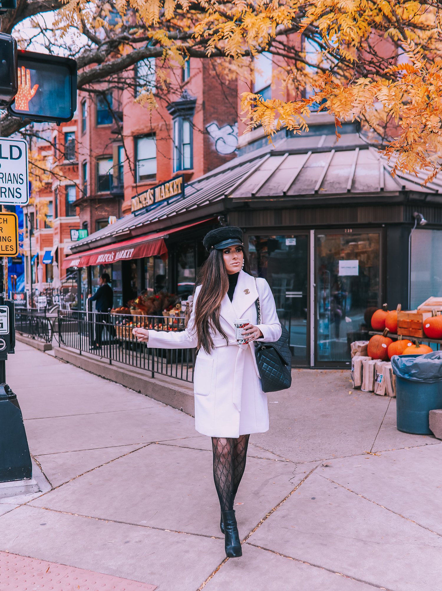 Classic Winter Outfit featured by top US fashion blog, The Sweetest Thing: image of a woman wearing an Express white coat, an Express black turtleneck, an Express tweed skirt, Gucci tights, and a Chanel bag. | fall outfit ideas pinterest 2019, black gucci tights outfit idea, pinterest gucci tight outfit idea, emily ann gemma, express fall fashion 2019, emily ann gemma, Chanel XXL airlines tote black-2