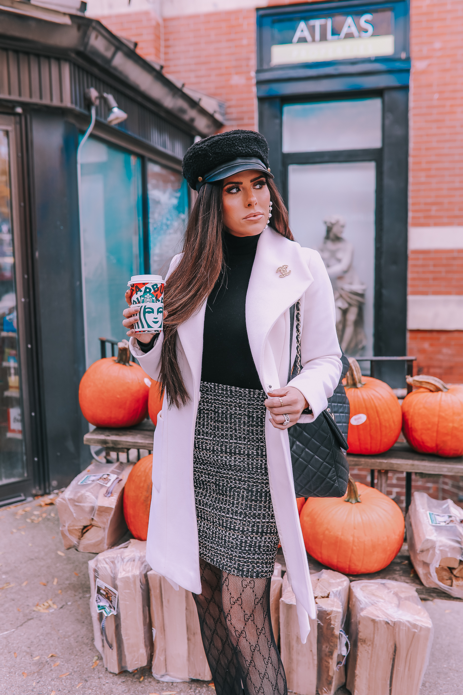 Classic Winter Outfit featured by top US fashion blog, The Sweetest Thing: image of a woman wearing an Express white coat, an Express black turtleneck, an Express tweed skirt, Gucci tights, and a Chanel bag. | fall outfit ideas pinterest 2019, black gucci tights outfit idea, pinterest gucci tight outfit idea, emily ann gemma, express fall fashion 2019, emily ann gemma, Chanel XXL airlines tote black-2