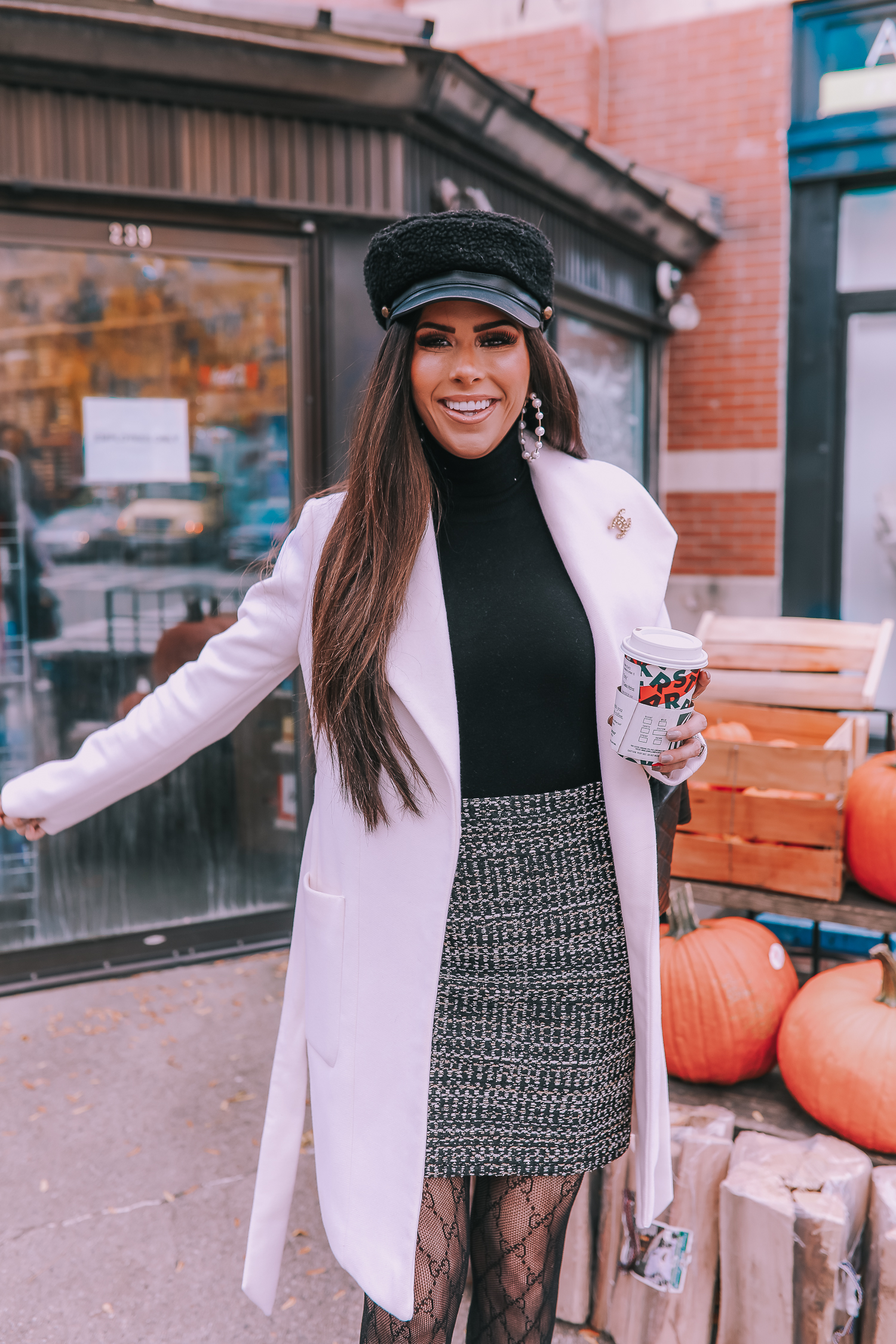 Classic Winter Outfit featured by top US fashion blog, The Sweetest Thing: image of a woman wearing an Express white coat, an Express black turtleneck, an Express tweed skirt, Gucci tights, and a Chanel bag. | fall outfit ideas pinterest 2019, black gucci tights outfit idea, pinterest gucci tight outfit idea, emily ann gemma, express fall fashion 2019, emily ann gemma, Chanel XXL airlines tote black-2