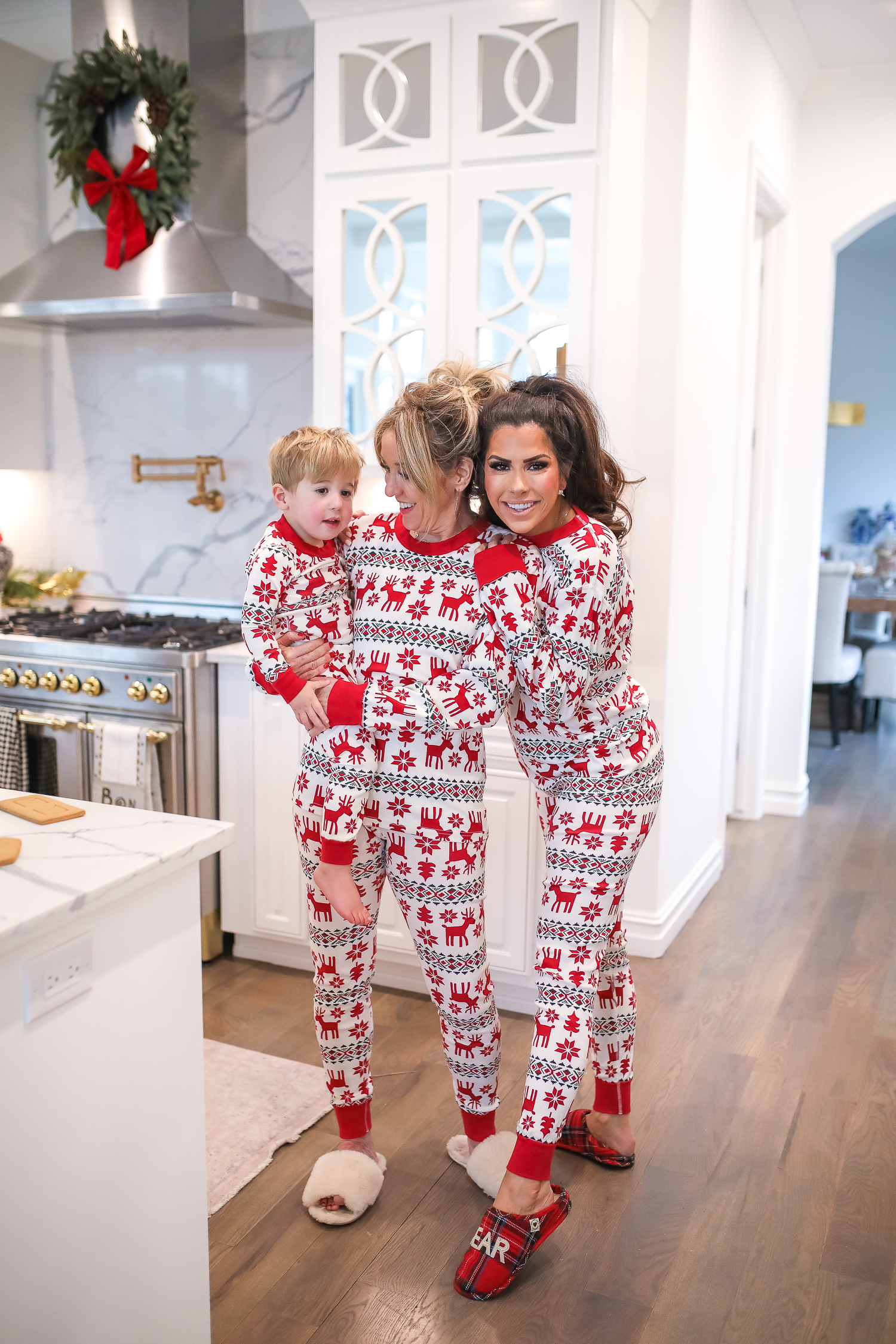 Hanna Anderson pjs christmas, family matching christmas pajamas, christmas decor pajamas 2019 pinterest, babies christmas pajamas matching, the sweetest thing blog-5 | Coco & Crew In Matching Hanna Andersson Christmas Pajamas by popular Oklahoma life and style blog, The Sweetest Thing: image of a family decorating gingerbread houses and wearing Hanna Andersson Long John Pajamas In Organic Cotton, Hanna Andersson Adult Long John Pant In Organic Cotton, Hanna Andersson Women's Long John Top In Organic Cotton, Hanna Andersson Adult Long John Top In Organic Cotton, and Hanna Andersson Adult Long John Pant In Organic Cotton.