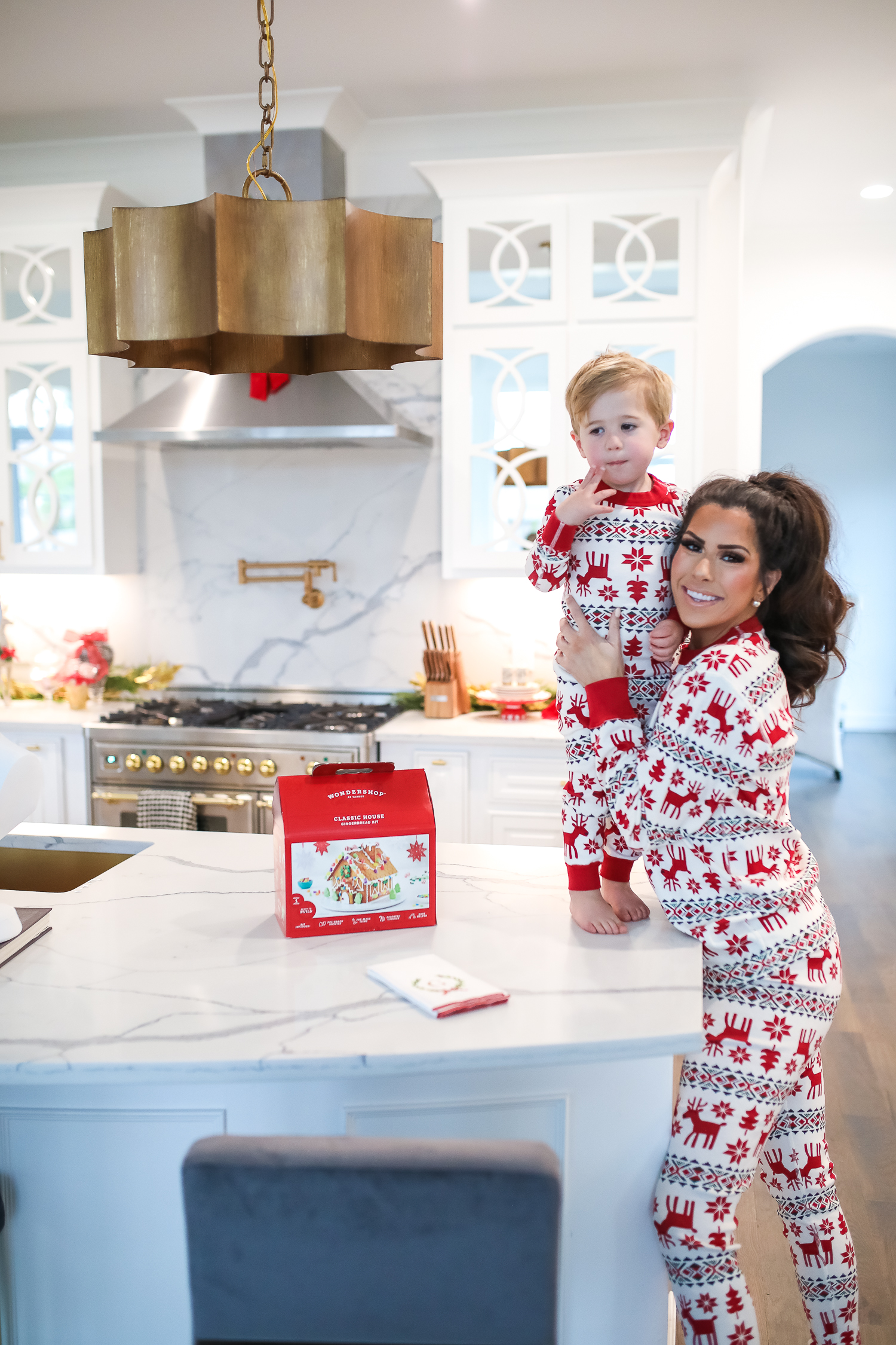 Hanna Anderson pjs christmas, family matching christmas pajamas, christmas decor pajamas 2019 pinterest, babies christmas pajamas matching, the sweetest thing blog-5 | Coco & Crew In Matching Hanna Andersson Christmas Pajamas by popular Oklahoma life and style blog, The Sweetest Thing: image of a family decorating gingerbread houses and wearing Hanna Andersson Long John Pajamas In Organic Cotton, Hanna Andersson Adult Long John Pant In Organic Cotton, Hanna Andersson Women's Long John Top In Organic Cotton, Hanna Andersson Adult Long John Top In Organic Cotton, and Hanna Andersson Adult Long John Pant In Organic Cotton.