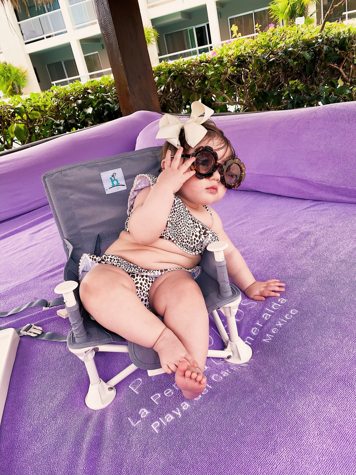 baby fashionista in swimsuit, baby girl in swimsuit, emily gemma | A YEAR IN REVIEW : MASSIVE 2019 INSTAGRAM RECAP by popular Oklahoma life and style blog, The Sweetest Thing: image of a baby sitting outside and wearing a Janie and Jack JUNO VALENTINE CHEETAH 2-PIECE SWIMSUIT and Amazon ADEWU Sunglasses for Kids Round Flower Cute Glasses.