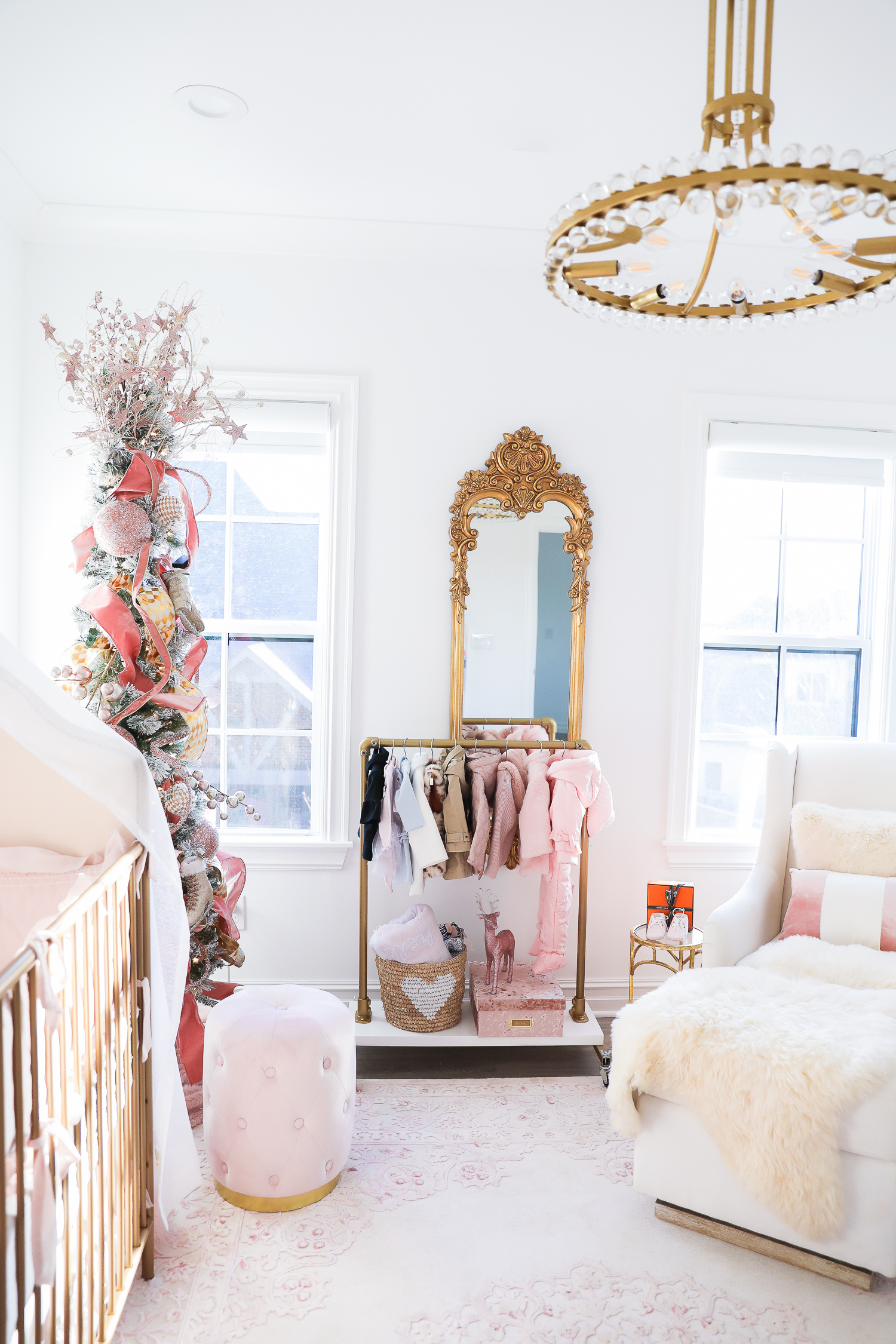 baby girl nursery inspiration christmas pinterest, baby girl nursery christmas tree, emily gemma, gold baby garment rack, the sweetest thing blog-2 |  Sophia’s Baby Girl Nursery at Christmastime by popular Oklahoma life and style blog, The Sweetest Thing: image of a girl nursery decorated with a Nordstrom Nolene Sequin Party Dress, Pottery Barn Kids Merced Glider & Ottoman, Wayfair Piper 2-in-1 Convertible Crib, RH Baby & Child NEW RUFFLE APPLIQUÉD ORGANIC VOILE NURSERY BEDDING COLLECTION, Wayfair Fontanne Oriental Pink/White Area Rug, Overstock Clover 8-light Aged Brass Chandelier, Horchow Sophia Rectangular Dressing Mirror, Etsy ShopAndisList Childrens standard rack, Pottery Barn Kids Raffia Heart Baskets, RH Baby & Child GILT DEMILUNE CANOPY BED CROWN, Walmart Holiday Time Pre-Lit Snow-Flocked Colorado Artificial Christmas Tree, 7', White Lights, Target Wondershop Glitter Deer Decorative Figurine Blush, T.J. Maxx pink velvet storage box, Wayfair Arnulfo 6 Drawer Double Dresser, Nordstrom Nursery Essential Gift Set, Nordstrom Sophie la Girafe Teething Toy, Glamboxes GLAMstand Hair Accessory Organizer, Serena & Lily Jenn Thatcher painting, Pottery Barn Kids Luxe Chamois Changing Pad, Crate & Kids Acrylic Shelf Bookcase, RH Baby and Child ANTIQUED GILT WOOD LETTER, Wayfair Luxe Solid Faux Fur Throw Pillow, Gap Toddler Cable-Knit Pom Beanie, Maisonette SteamLine Luggage *Exclusive* Vanity Case, Smocked Auctions NUTCRACKER SMOCKED BISHOP PINK GINGHAM, Nordstrom Ugg Jesse Bow Fluff Bootie, Overstock Safavieh Couture Carnation Round Tufted Ottoman, Pottery Barn Kids Blush Velvet Nursery Storage, and Nordstrom Chenille Blanket.