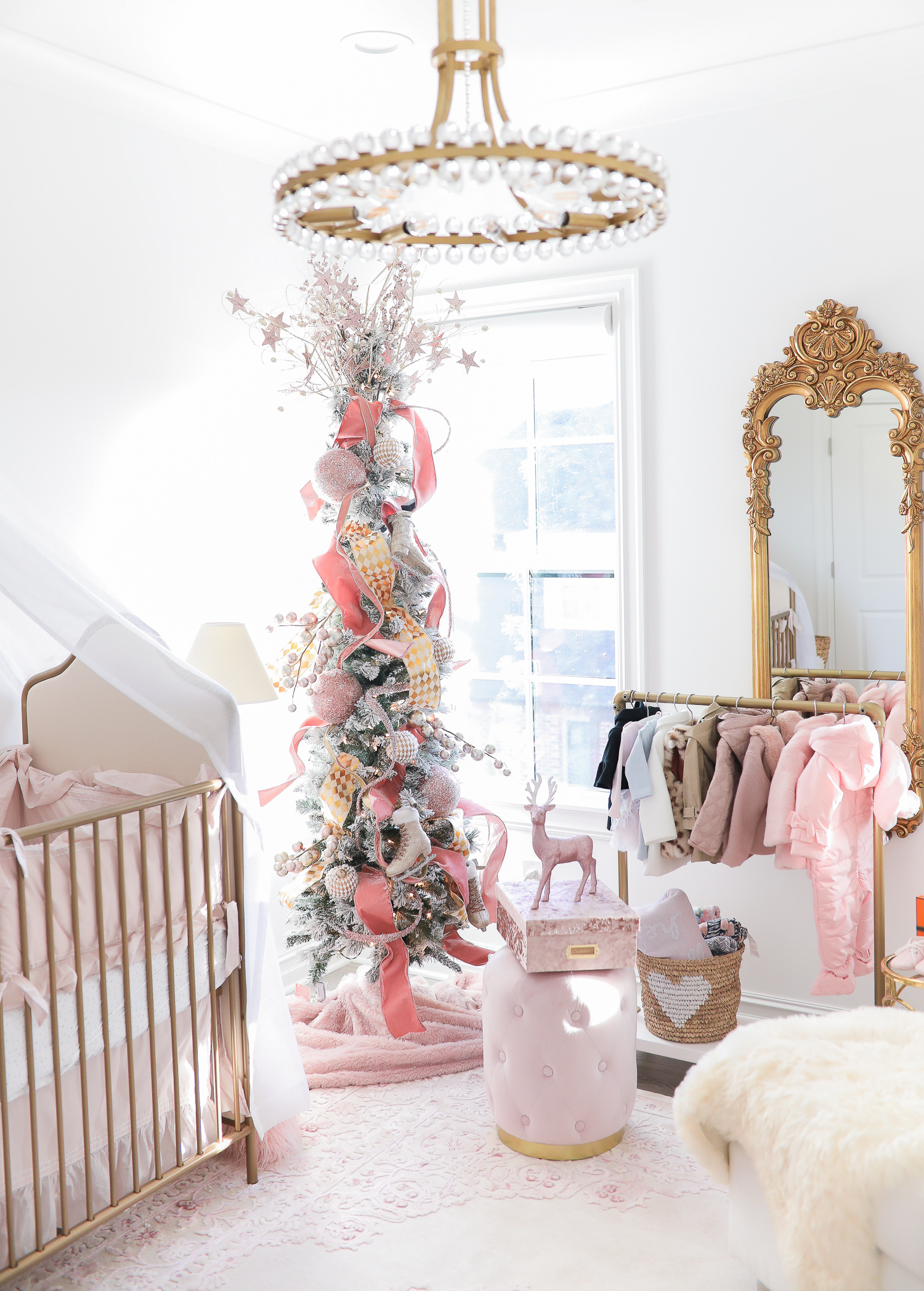 baby girl nursery inspiration christmas pinterest, baby girl nursery christmas tree, emily gemma, gold baby garment rack, the sweetest thing blog-2 | Sophia’s Baby Girl Nursery at Christmastime by popular Oklahoma life and style blog, The Sweetest Thing: image of a girl nursery decorated with a Nordstrom Nolene Sequin Party Dress, Pottery Barn Kids Merced Glider & Ottoman, Wayfair Piper 2-in-1 Convertible Crib, RH Baby & Child NEW RUFFLE APPLIQUÉD ORGANIC VOILE NURSERY BEDDING COLLECTION, Wayfair Fontanne Oriental Pink/White Area Rug, Overstock Clover 8-light Aged Brass Chandelier, Horchow Sophia Rectangular Dressing Mirror, Etsy ShopAndisList Childrens standard rack, Pottery Barn Kids Raffia Heart Baskets, RH Baby & Child GILT DEMILUNE CANOPY BED CROWN, Walmart Holiday Time Pre-Lit Snow-Flocked Colorado Artificial Christmas Tree, 7', White Lights, Target Wondershop Glitter Deer Decorative Figurine Blush, T.J. Maxx pink velvet storage box, Wayfair Arnulfo 6 Drawer Double Dresser, Nordstrom Nursery Essential Gift Set, Nordstrom Sophie la Girafe Teething Toy, Glamboxes GLAMstand Hair Accessory Organizer, Serena & Lily Jenn Thatcher painting, Pottery Barn Kids Luxe Chamois Changing Pad, Crate & Kids Acrylic Shelf Bookcase, RH Baby and Child ANTIQUED GILT WOOD LETTER, Wayfair Luxe Solid Faux Fur Throw Pillow, Gap Toddler Cable-Knit Pom Beanie, Maisonette SteamLine Luggage *Exclusive* Vanity Case, Smocked Auctions NUTCRACKER SMOCKED BISHOP PINK GINGHAM, Nordstrom Ugg Jesse Bow Fluff Bootie, Overstock Safavieh Couture Carnation Round Tufted Ottoman, Pottery Barn Kids Blush Velvet Nursery Storage, and Nordstrom Chenille Blanket.