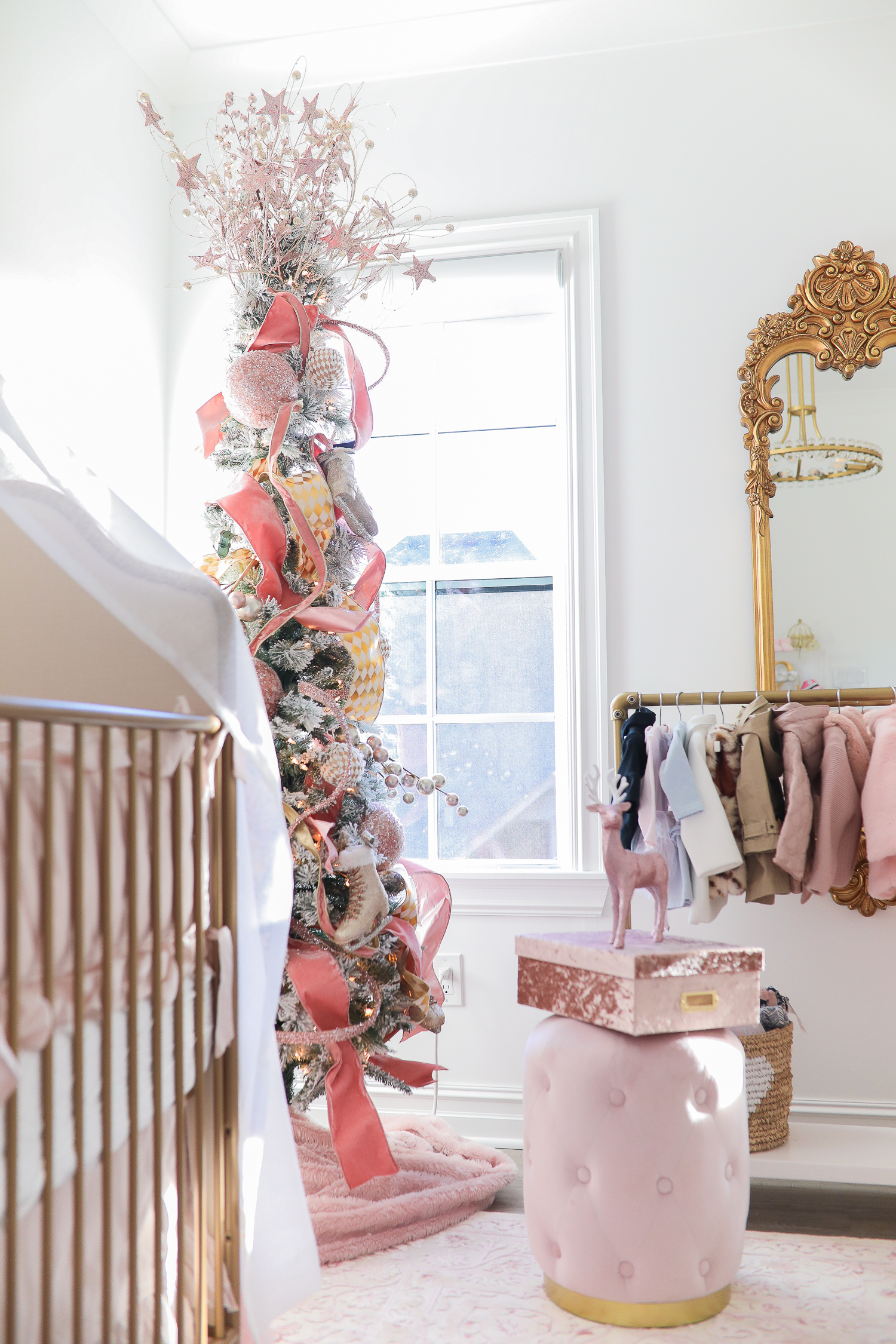 baby girl nursery inspiration christmas pinterest, baby girl nursery christmas tree, emily gemma, gold baby garment rack, the sweetest thing blog-2 |  Sophia’s Baby Girl Nursery at Christmastime by popular Oklahoma life and style blog, The Sweetest Thing: image of a girl nursery decorated with a Nordstrom Nolene Sequin Party Dress, Pottery Barn Kids Merced Glider & Ottoman, Wayfair Piper 2-in-1 Convertible Crib, RH Baby & Child NEW RUFFLE APPLIQUÉD ORGANIC VOILE NURSERY BEDDING COLLECTION, Wayfair Fontanne Oriental Pink/White Area Rug, Overstock Clover 8-light Aged Brass Chandelier, Horchow Sophia Rectangular Dressing Mirror, Etsy ShopAndisList Childrens standard rack, Pottery Barn Kids Raffia Heart Baskets, RH Baby & Child GILT DEMILUNE CANOPY BED CROWN, Walmart Holiday Time Pre-Lit Snow-Flocked Colorado Artificial Christmas Tree, 7', White Lights, Target Wondershop Glitter Deer Decorative Figurine Blush, T.J. Maxx pink velvet storage box, Wayfair Arnulfo 6 Drawer Double Dresser, Nordstrom Nursery Essential Gift Set, Nordstrom Sophie la Girafe Teething Toy, Glamboxes GLAMstand Hair Accessory Organizer, Serena & Lily Jenn Thatcher painting, Pottery Barn Kids Luxe Chamois Changing Pad, Crate & Kids Acrylic Shelf Bookcase, RH Baby and Child ANTIQUED GILT WOOD LETTER, Wayfair Luxe Solid Faux Fur Throw Pillow, Gap Toddler Cable-Knit Pom Beanie, Maisonette SteamLine Luggage *Exclusive* Vanity Case, Smocked Auctions NUTCRACKER SMOCKED BISHOP PINK GINGHAM, Nordstrom Ugg Jesse Bow Fluff Bootie, Overstock Safavieh Couture Carnation Round Tufted Ottoman, Pottery Barn Kids Blush Velvet Nursery Storage, and Nordstrom Chenille Blanket.