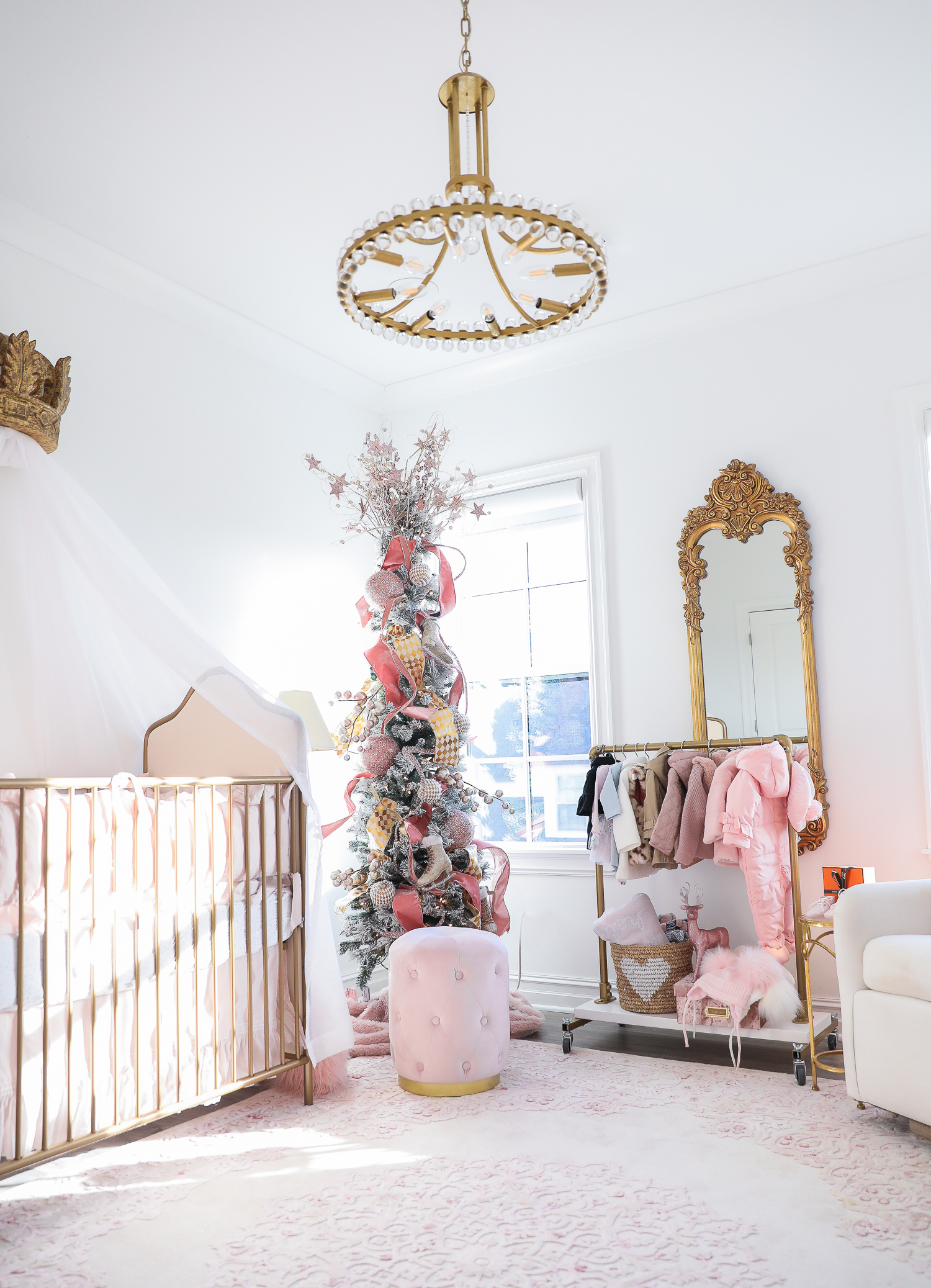 baby girl nursery inspiration christmas pinterest, baby girl nursery christmas tree, emily gemma, gold baby garment rack, the sweetest thing blog-2 |  Sophia’s Baby Girl Nursery at Christmastime by popular Oklahoma life and style blog, The Sweetest Thing: image of a girl nursery decorated with a Nordstrom Nolene Sequin Party Dress, Pottery Barn Kids Merced Glider & Ottoman, Wayfair Piper 2-in-1 Convertible Crib, RH Baby & Child NEW RUFFLE APPLIQUÉD ORGANIC VOILE NURSERY BEDDING COLLECTION, Wayfair Fontanne Oriental Pink/White Area Rug, Overstock Clover 8-light Aged Brass Chandelier, Horchow Sophia Rectangular Dressing Mirror, Etsy ShopAndisList Childrens standard rack, Pottery Barn Kids Raffia Heart Baskets, RH Baby & Child GILT DEMILUNE CANOPY BED CROWN, Walmart Holiday Time Pre-Lit Snow-Flocked Colorado Artificial Christmas Tree, 7', White Lights, Target Wondershop Glitter Deer Decorative Figurine Blush, T.J. Maxx pink velvet storage box, Wayfair Arnulfo 6 Drawer Double Dresser, Nordstrom Nursery Essential Gift Set, Nordstrom Sophie la Girafe Teething Toy, Glamboxes GLAMstand Hair Accessory Organizer, Serena & Lily Jenn Thatcher painting, Pottery Barn Kids Luxe Chamois Changing Pad, Crate & Kids Acrylic Shelf Bookcase, RH Baby and Child ANTIQUED GILT WOOD LETTER, Wayfair Luxe Solid Faux Fur Throw Pillow, Gap Toddler Cable-Knit Pom Beanie, Maisonette SteamLine Luggage *Exclusive* Vanity Case, Smocked Auctions NUTCRACKER SMOCKED BISHOP PINK GINGHAM, Nordstrom Ugg Jesse Bow Fluff Bootie, Overstock Safavieh Couture Carnation Round Tufted Ottoman, Pottery Barn Kids Blush Velvet Nursery Storage, and Nordstrom Chenille Blanket.