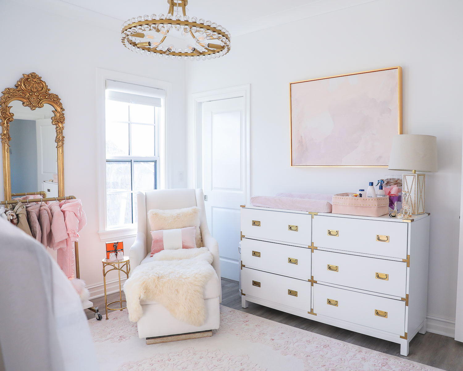 baby girl nursery inspiration christmas pinterest, baby girl nursery christmas tree, emily gemma, gold baby garment rack, the sweetest thing blog-2 |  Sophia’s Baby Girl Nursery at Christmastime by popular Oklahoma life and style blog, The Sweetest Thing: image of a girl nursery decorated with a Nordstrom Nolene Sequin Party Dress, Pottery Barn Kids Merced Glider & Ottoman, Wayfair Piper 2-in-1 Convertible Crib, RH Baby & Child NEW RUFFLE APPLIQUÉD ORGANIC VOILE NURSERY BEDDING COLLECTION, Wayfair Fontanne Oriental Pink/White Area Rug, Overstock Clover 8-light Aged Brass Chandelier, Horchow Sophia Rectangular Dressing Mirror, Etsy ShopAndisList Childrens standard rack, Pottery Barn Kids Raffia Heart Baskets, RH Baby & Child GILT DEMILUNE CANOPY BED CROWN, Walmart Holiday Time Pre-Lit Snow-Flocked Colorado Artificial Christmas Tree, 7', White Lights, Target Wondershop Glitter Deer Decorative Figurine Blush, T.J. Maxx pink velvet storage box, Wayfair Arnulfo 6 Drawer Double Dresser, Nordstrom Nursery Essential Gift Set, Nordstrom Sophie la Girafe Teething Toy, Glamboxes GLAMstand Hair Accessory Organizer, Serena & Lily Jenn Thatcher painting, Pottery Barn Kids Luxe Chamois Changing Pad, Crate & Kids Acrylic Shelf Bookcase, RH Baby and Child ANTIQUED GILT WOOD LETTER, Wayfair Luxe Solid Faux Fur Throw Pillow, Gap Toddler Cable-Knit Pom Beanie, Maisonette SteamLine Luggage *Exclusive* Vanity Case, Smocked Auctions NUTCRACKER SMOCKED BISHOP PINK GINGHAM, Nordstrom Ugg Jesse Bow Fluff Bootie, Overstock Safavieh Couture Carnation Round Tufted Ottoman, Pottery Barn Kids Blush Velvet Nursery Storage, and Nordstrom Chenille Blanket.