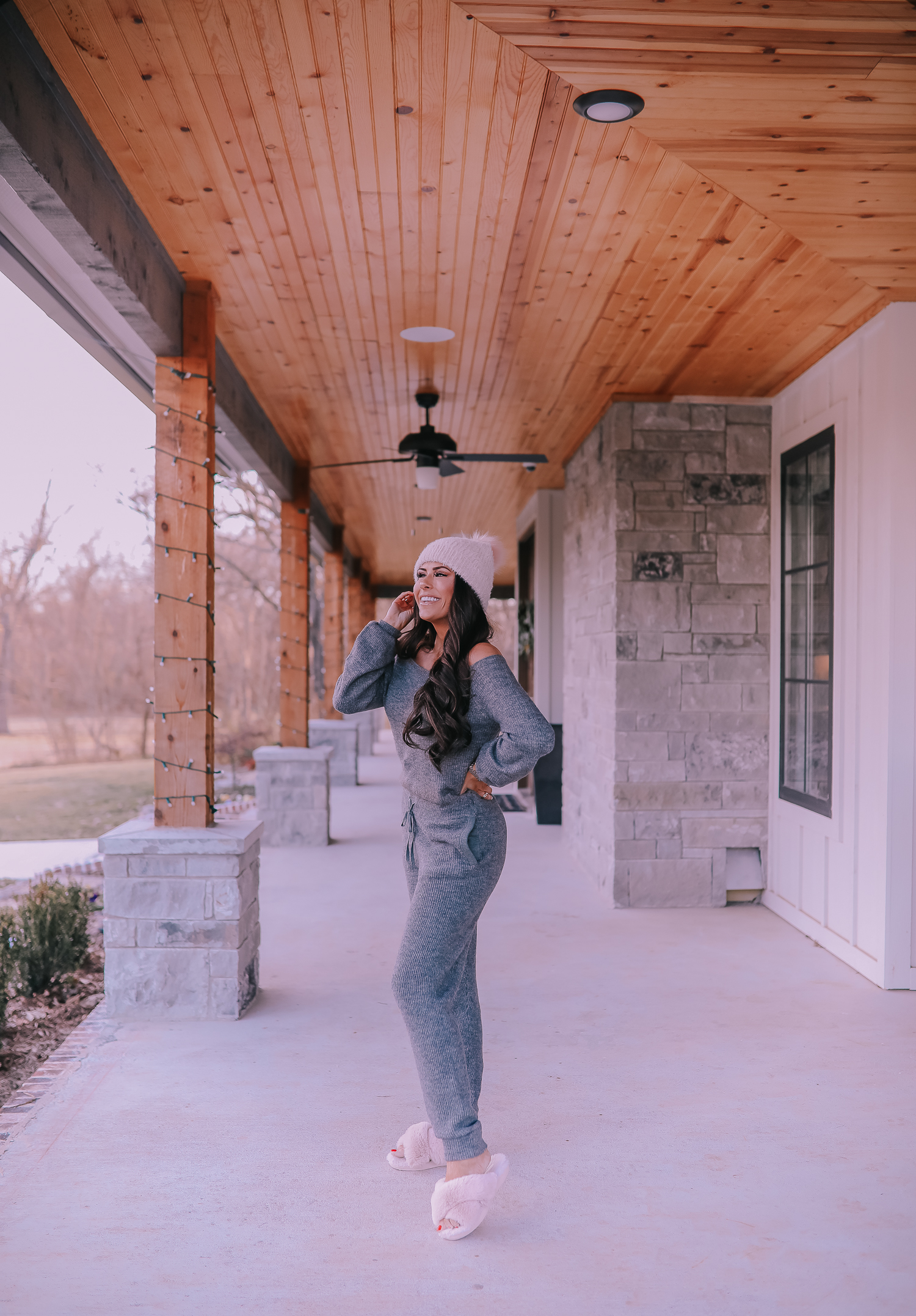 The Perfect Cozy Holiday Outfit [50% Off!] by popular Oklahoma fashion blog, The Sweetest Thing: image of a woman wearing an Express High Waisted Cozy Sweater Jogger Pant, Express Cozy Cropped Ribbed Sweater, Express Metallic Cable Knit Pom Beanie, and Express Criss-Cross Gem Embellished Faux Fur Slippers.