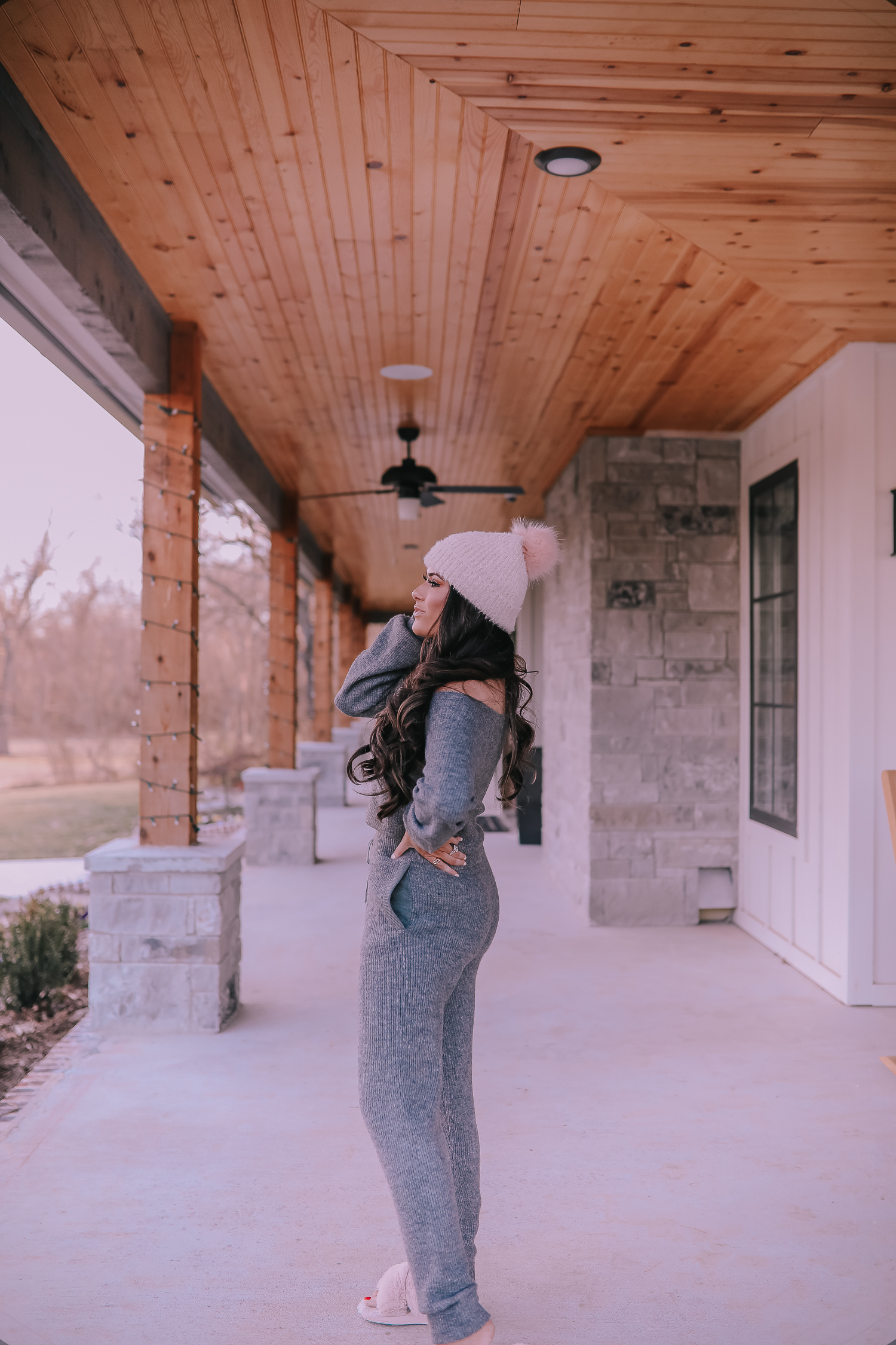 The Perfect Cozy Holiday Outfit [50% Off!] by popular Oklahoma fashion blog, The Sweetest Thing: image of a woman wearing an Express High Waisted Cozy Sweater Jogger Pant, Express Cozy Cropped Ribbed Sweater, Express Metallic Cable Knit Pom Beanie, and Express Criss-Cross Gem Embellished Faux Fur Slippers.
