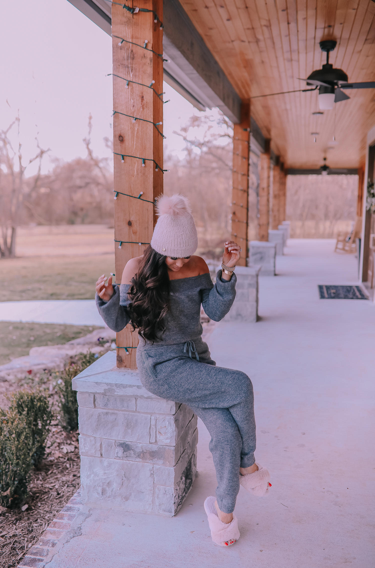 The Perfect Cozy Holiday Outfit [50% Off!] by popular Oklahoma fashion blog, The Sweetest Thing: image of a woman wearing an Express High Waisted Cozy Sweater Jogger Pant, Express Cozy Cropped Ribbed Sweater, Express Metallic Cable Knit Pom Beanie, and Express Criss-Cross Gem Embellished Faux Fur Slippers.